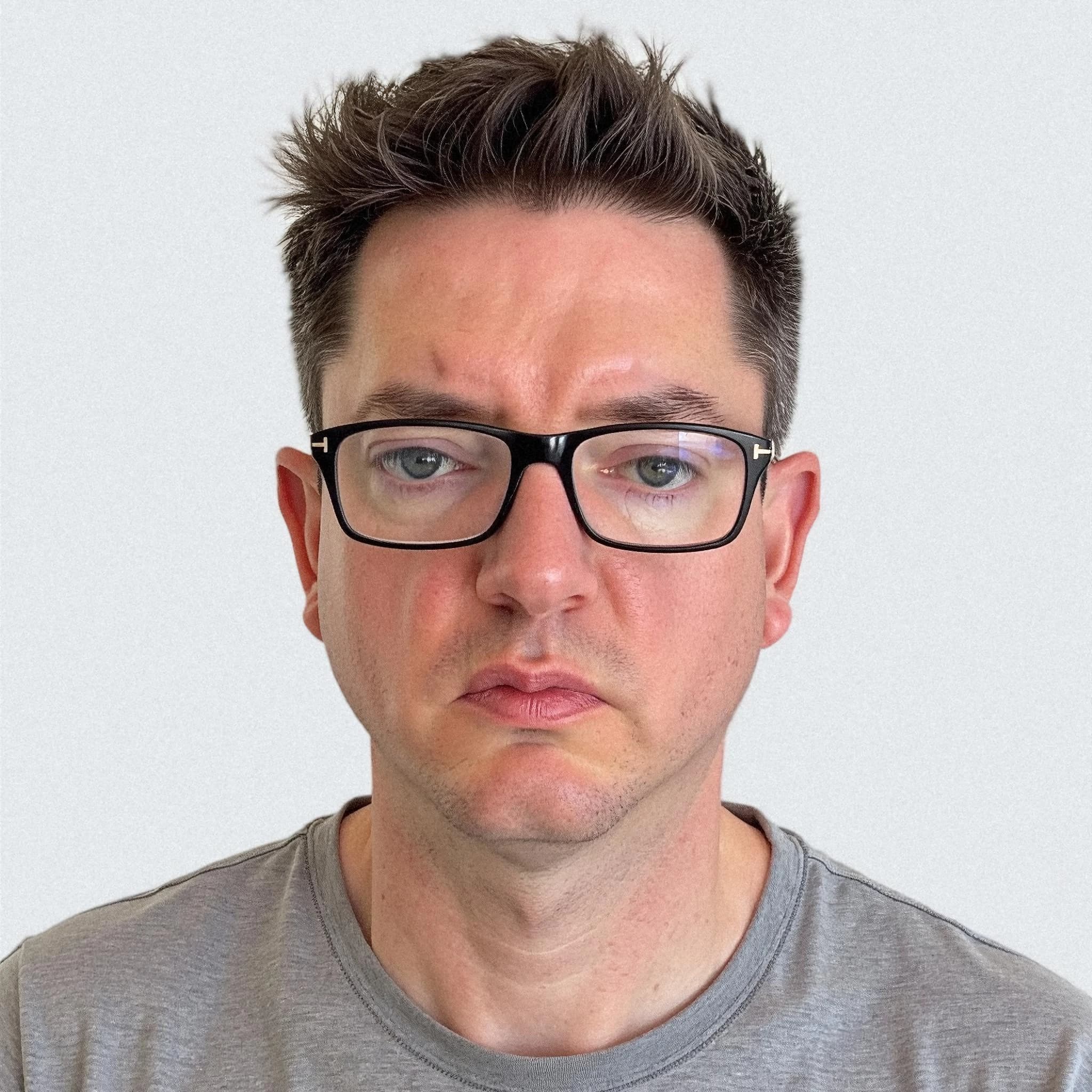 Professional headshot example: Man Indoor Gray Shirt Glasses — LinkedInHeadshots.ai