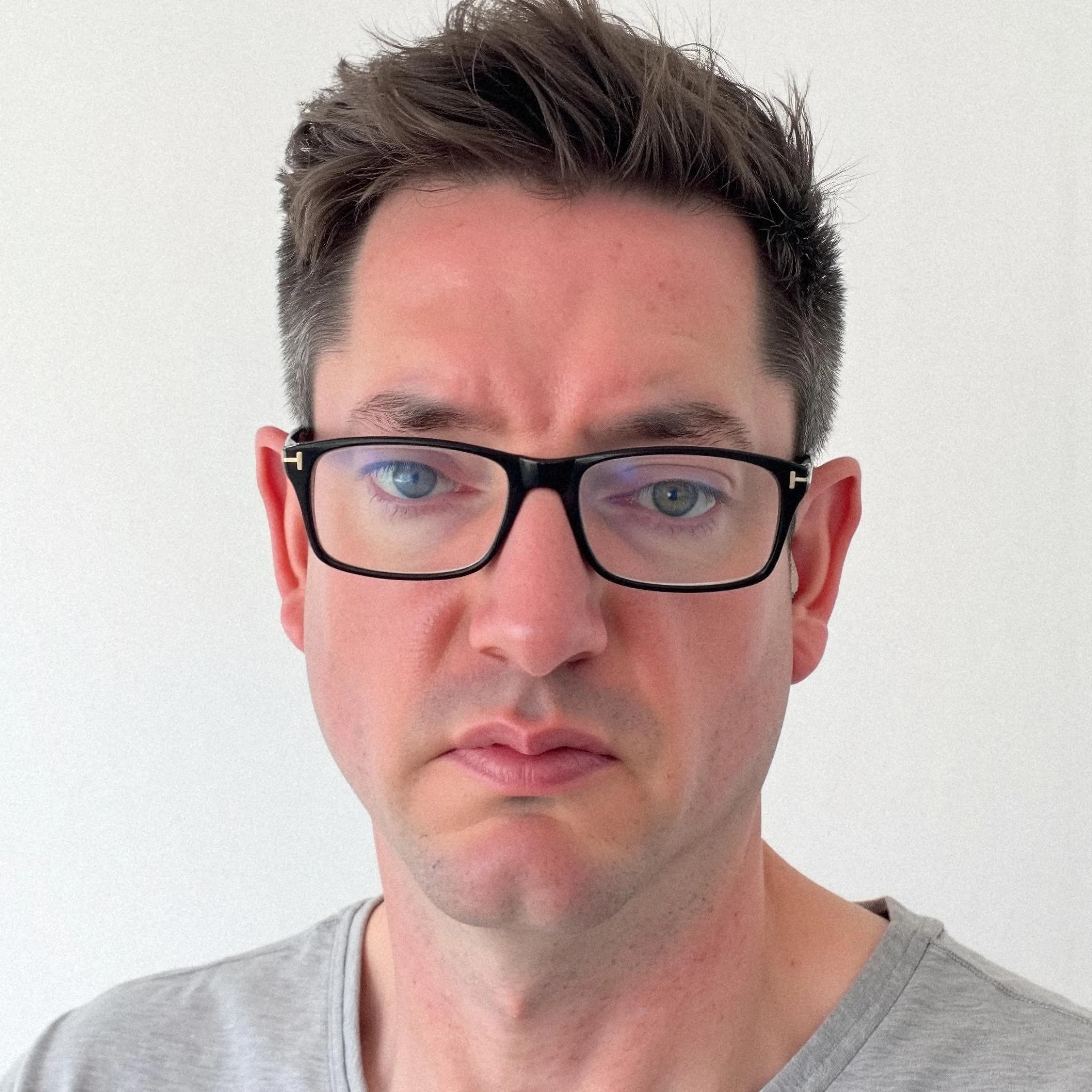 Professional headshot example: Man Indoor Gray Shirt Glasses 2 — LinkedInHeadshots.ai