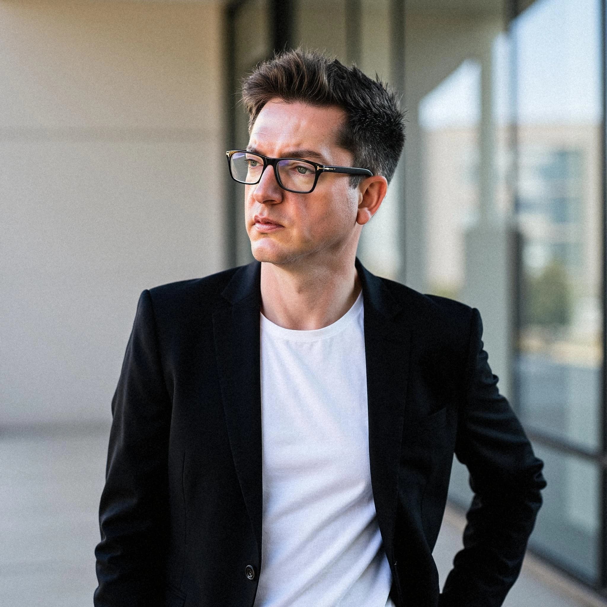 Professional headshot example: Man Office Black Jacket Standing — LinkedInHeadshots.ai