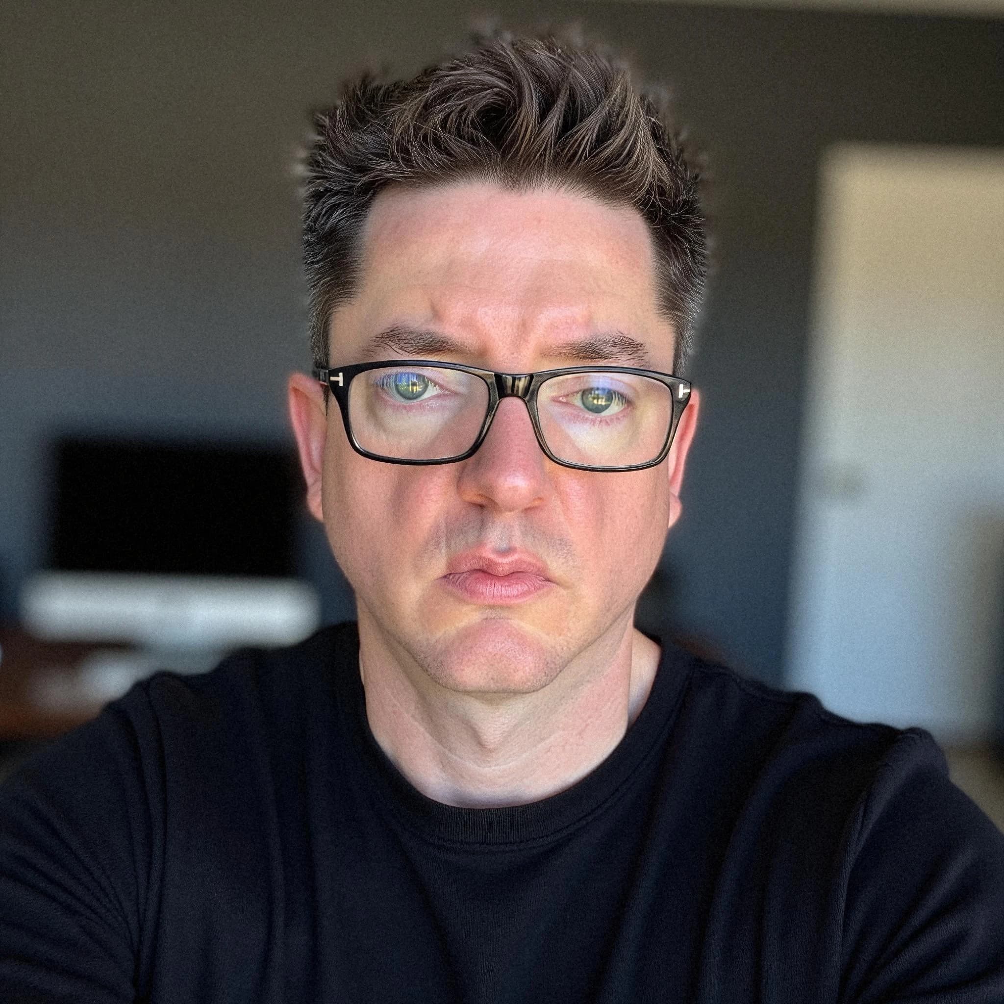 Professional headshot example: Man Office Black Shirt Glasses — LinkedInHeadshots.ai
