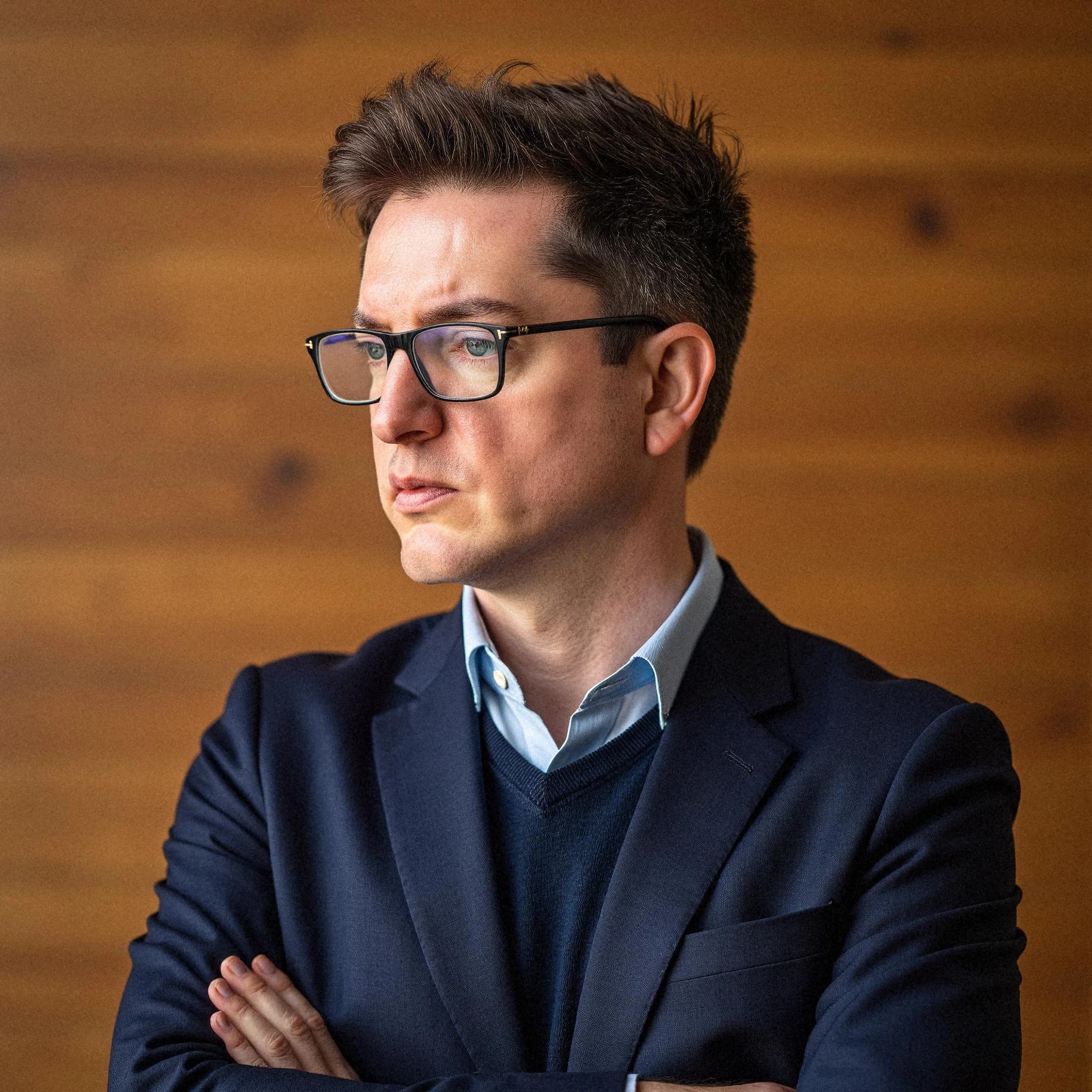 Professional headshot example: Man Office Suit Crossed Arms 6 — LinkedInHeadshots.ai