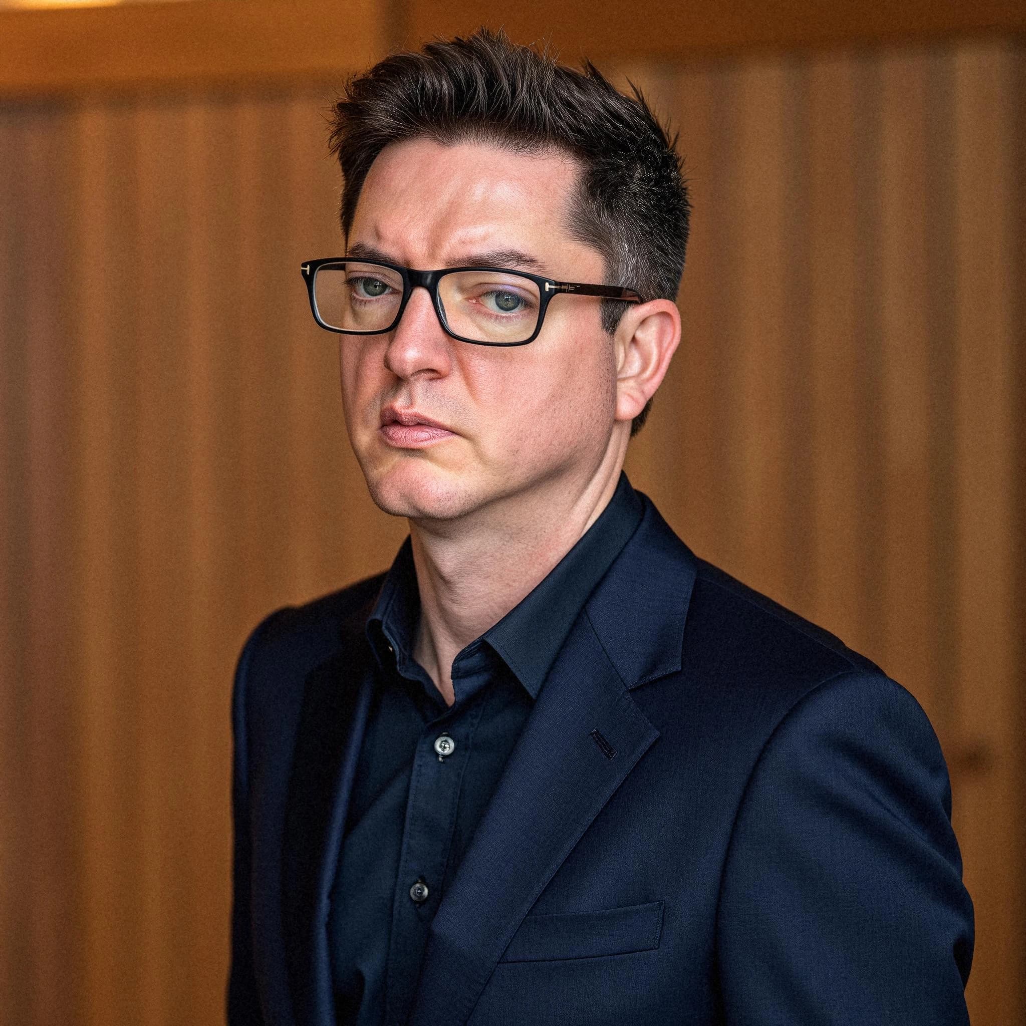 Professional headshot example: Man Office Suit Glasses Serious 5 — LinkedInHeadshots.ai