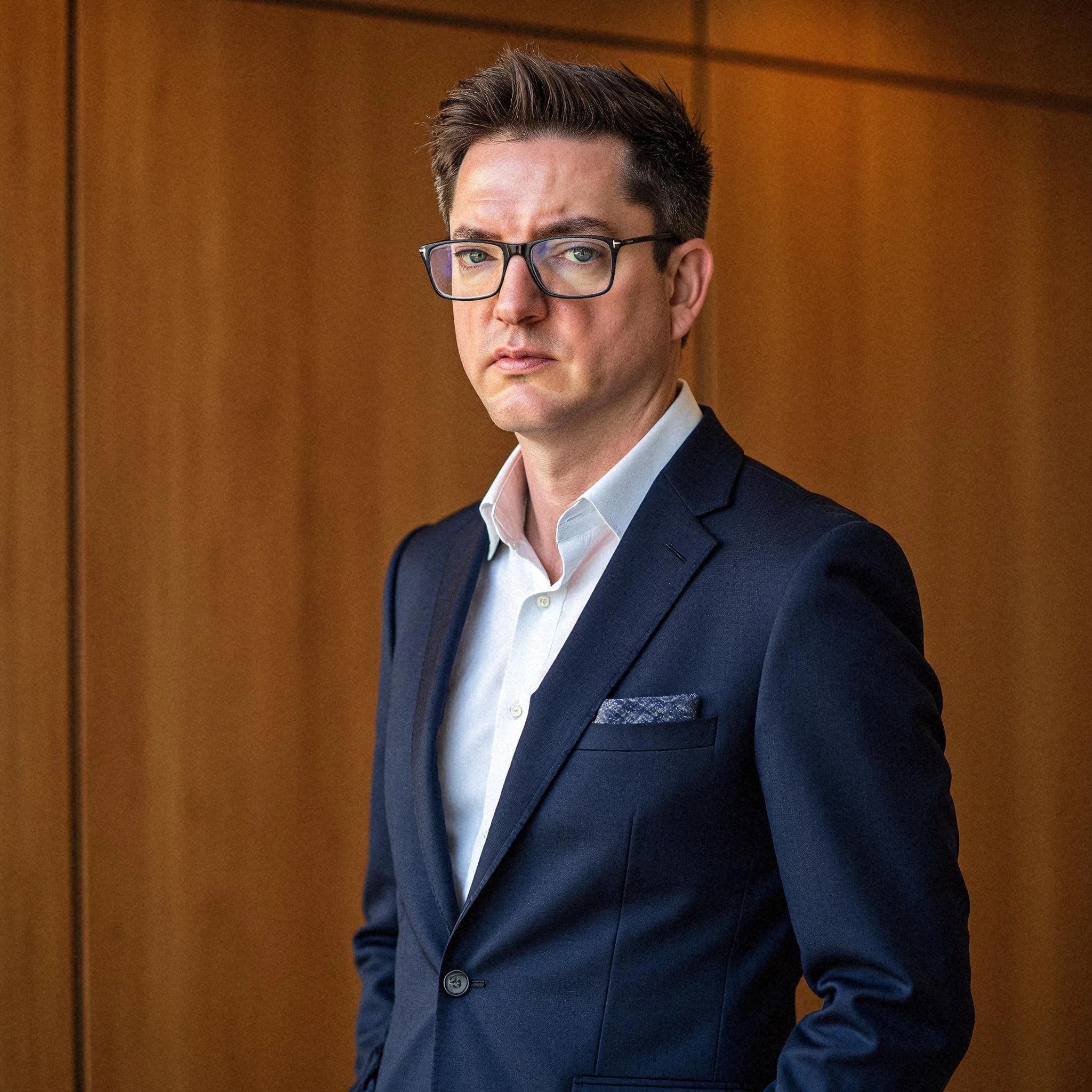 Professional headshot example: Man Office Suit Standing — LinkedInHeadshots.ai