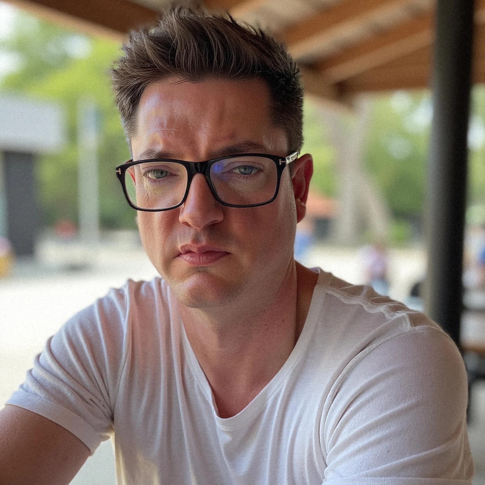 Professional headshot example: Man Outdoor White Shirt Sitting — LinkedInHeadshots.ai