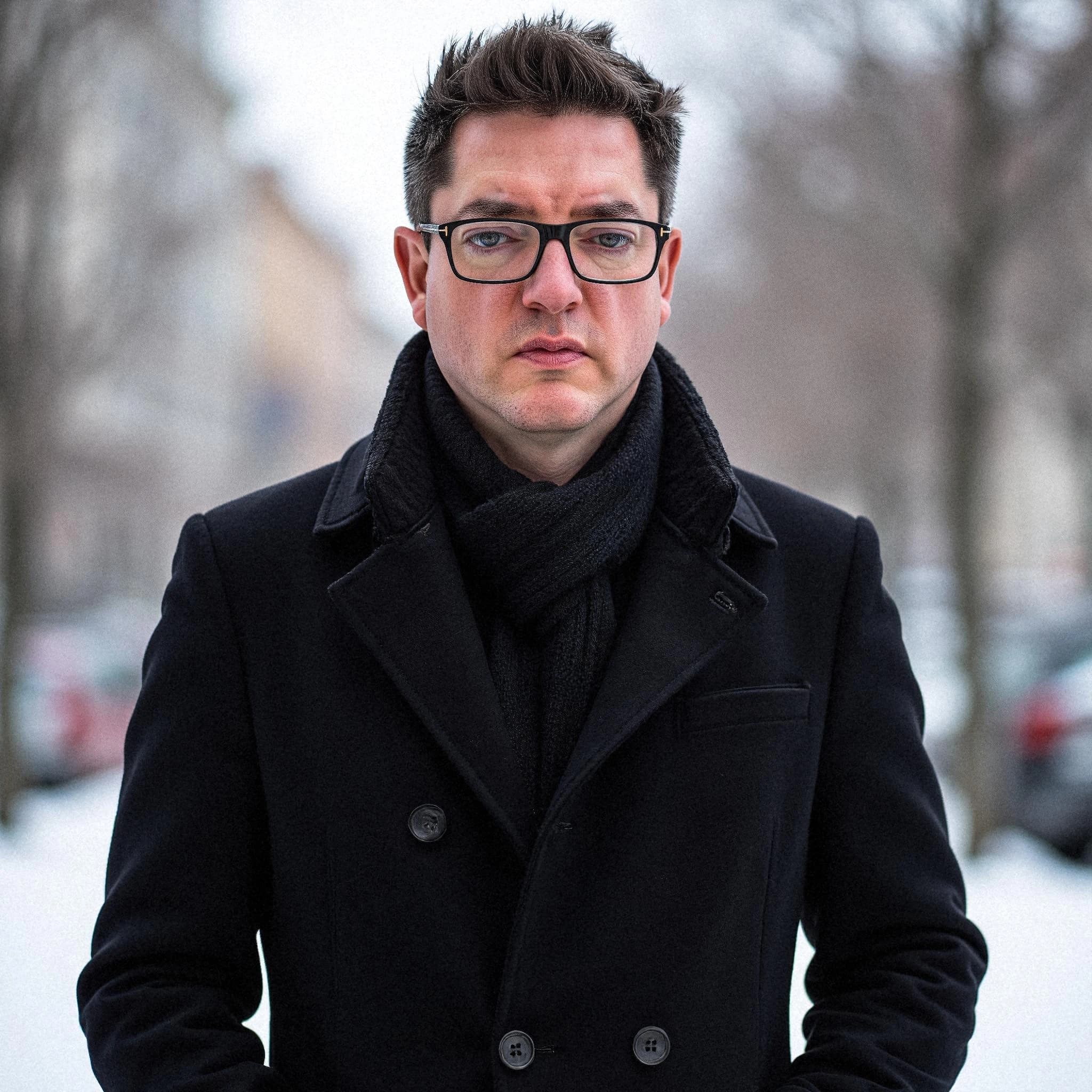 Professional headshot example: Man Outdoors Black Coat Standing — LinkedInHeadshots.ai