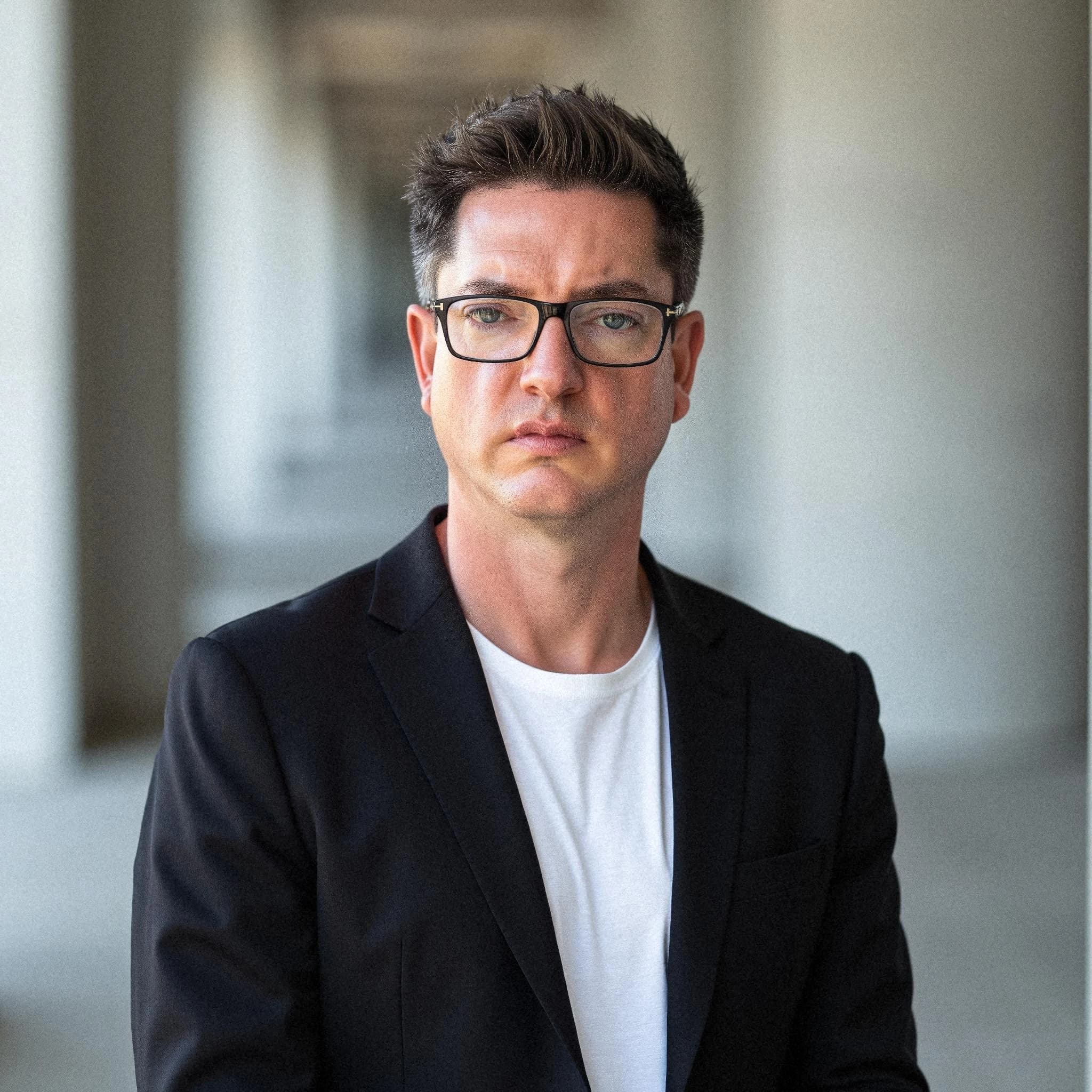 Professional headshot example: Man Outdoors Black Jacket Glasses — LinkedInHeadshots.ai