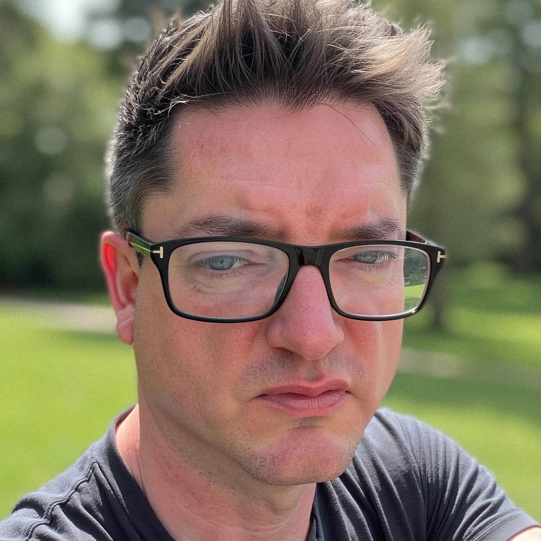 Professional headshot example: Man Outdoors Glasses Serious Expression — LinkedInHeadshots.ai
