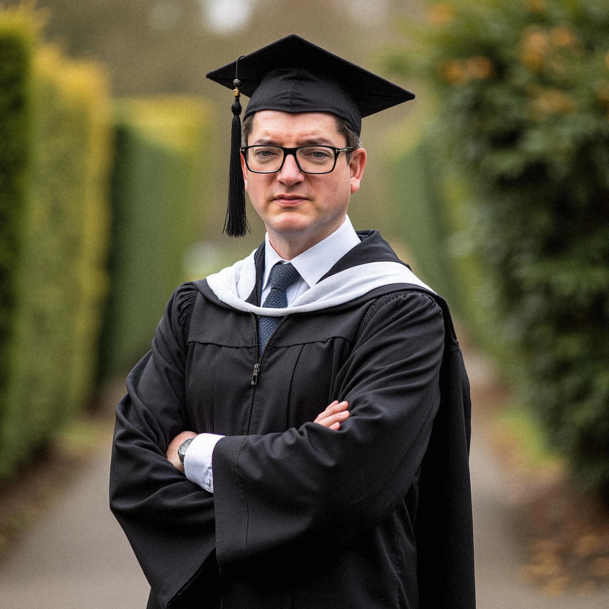 Professional headshot example: Man Outdoors Graduation Gown Crossed Arms 2 — LinkedInHeadshots.ai
