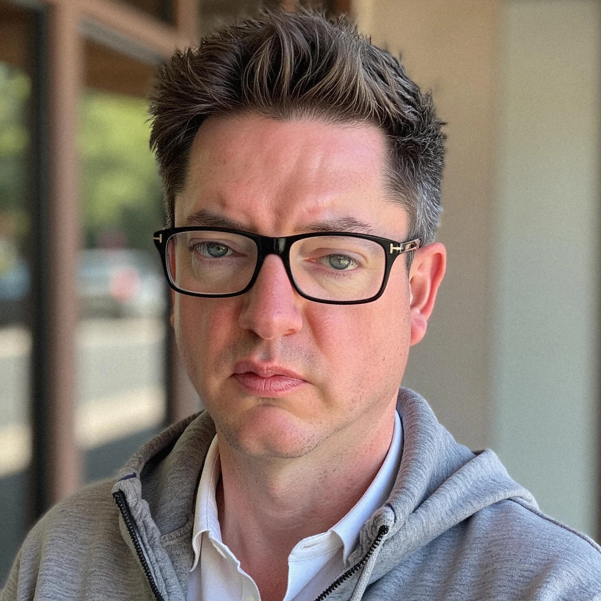 Professional headshot example: Man Outdoors Gray Hoodie Glasses 2 — LinkedInHeadshots.ai