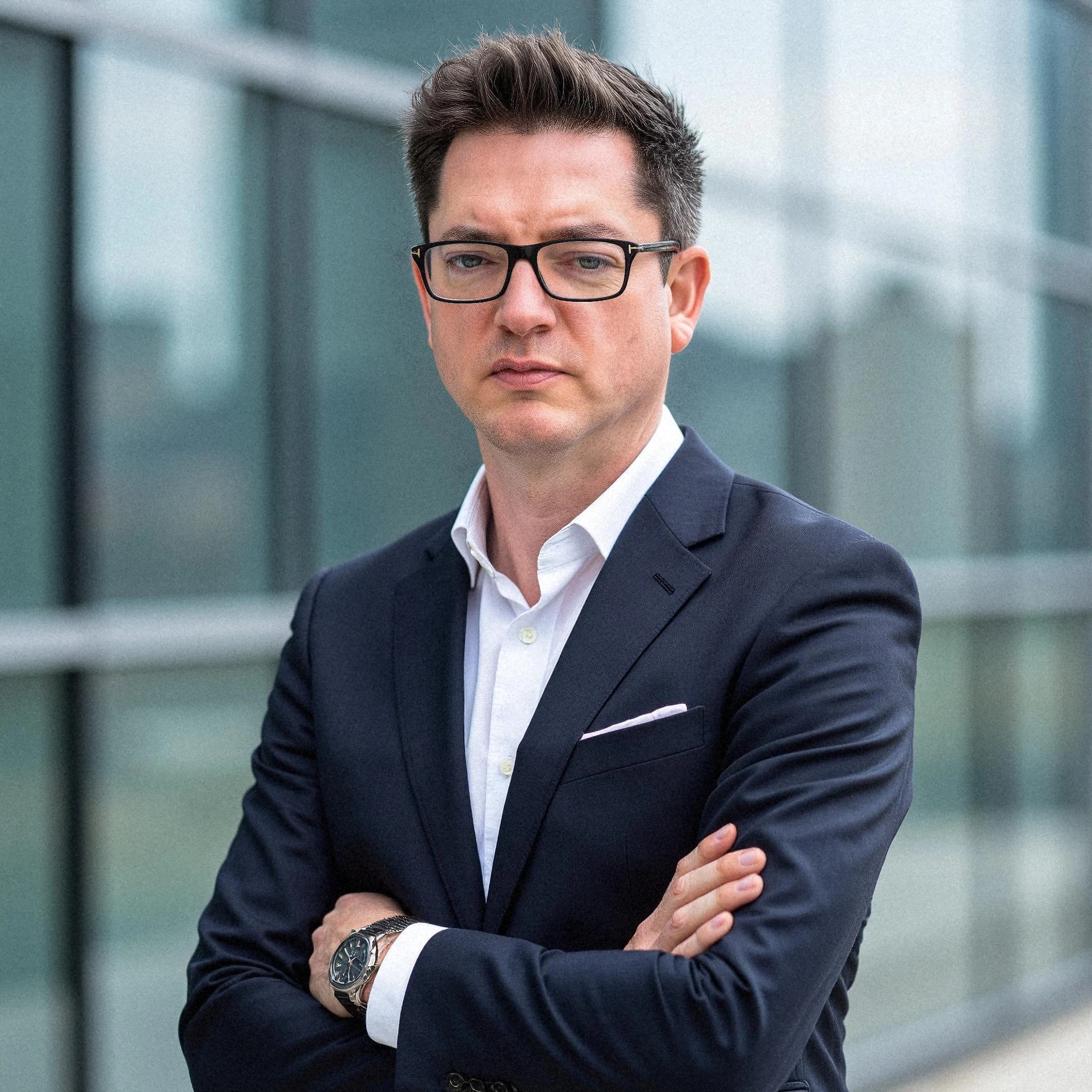 Professional headshot example: Man Outdoors Suit Crossed Arms — LinkedInHeadshots.ai