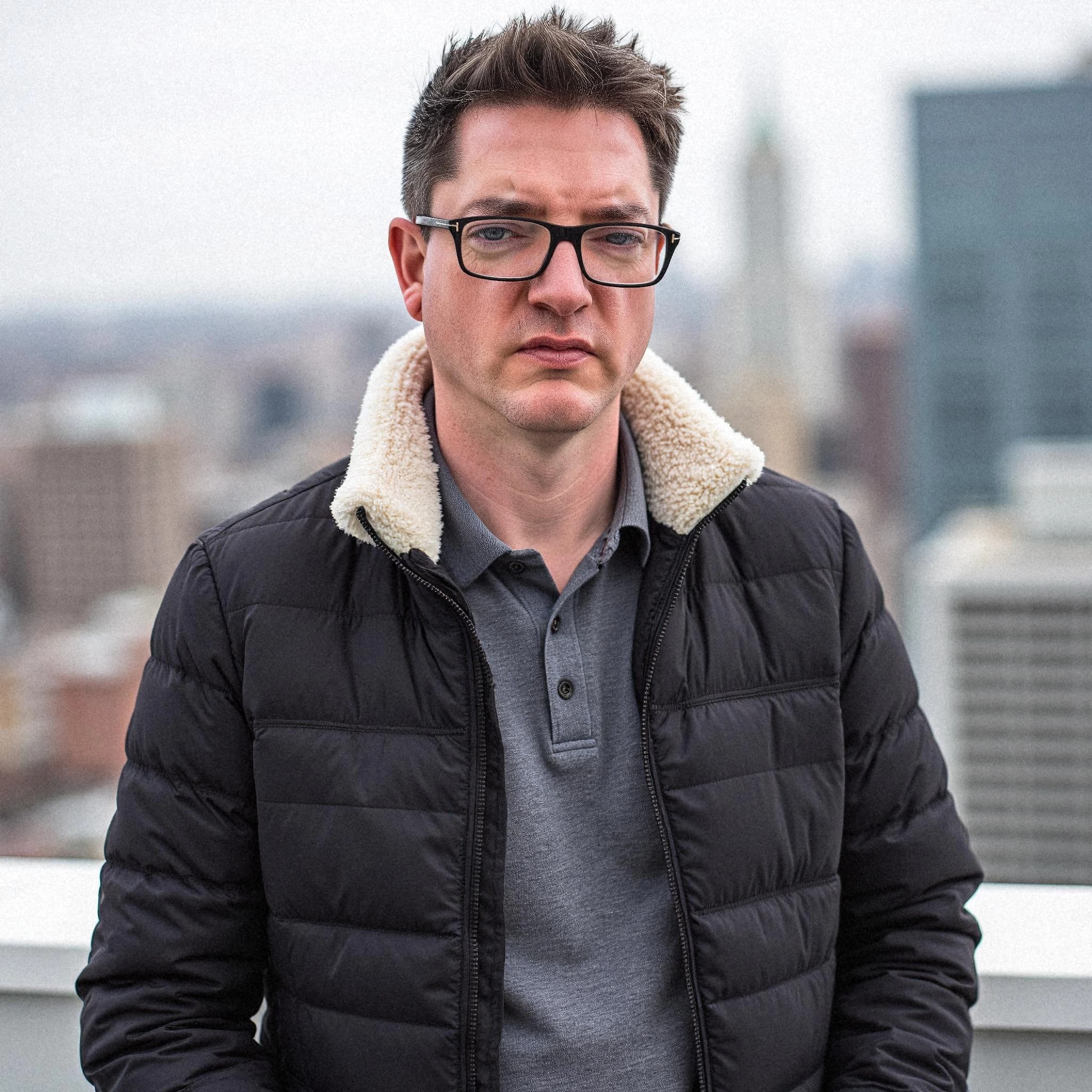 Professional headshot example: Man Rooftop Black Jacket Standing 3 — LinkedInHeadshots.ai