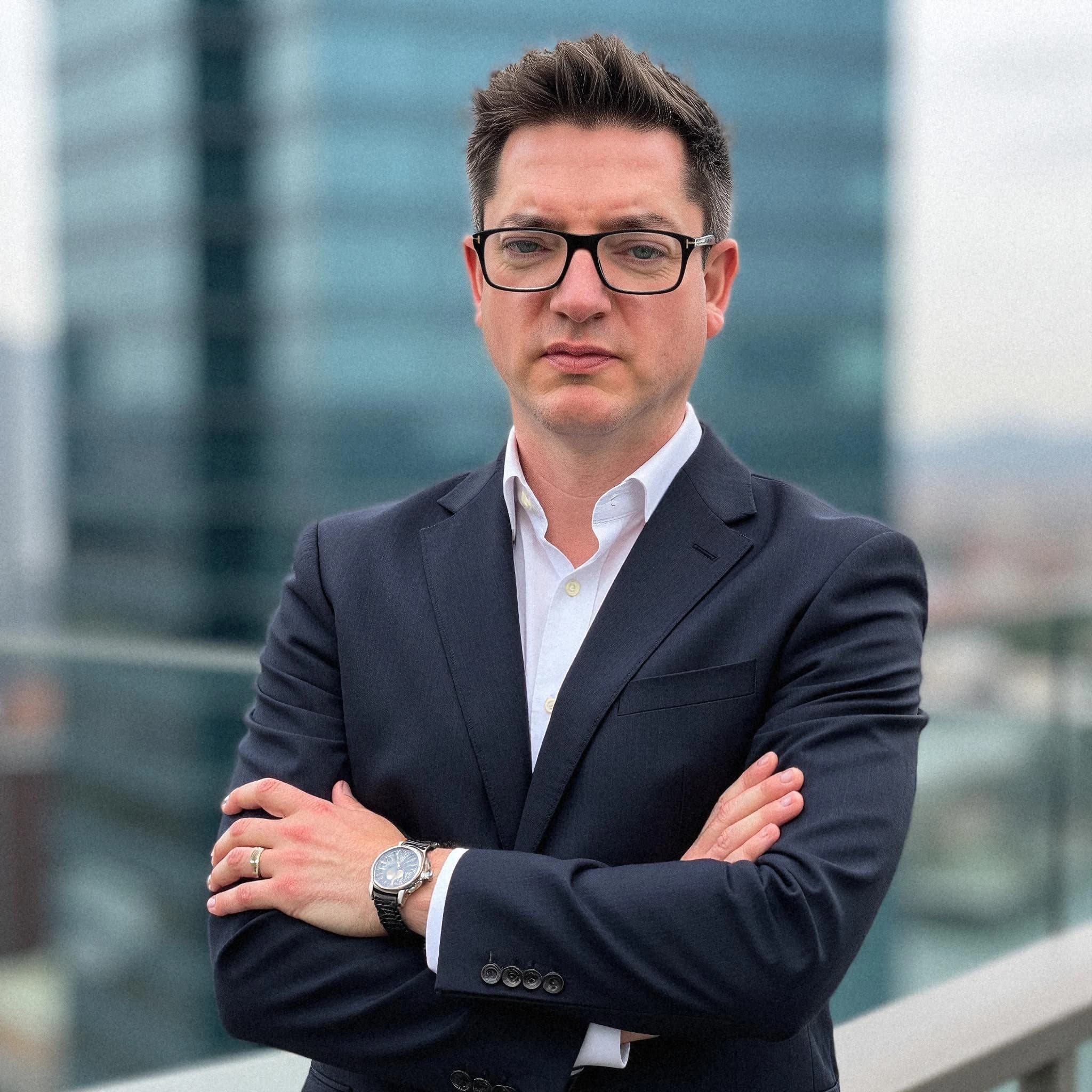 Professional headshot example: Man Rooftop Suit Arms Crossed 2 — LinkedInHeadshots.ai