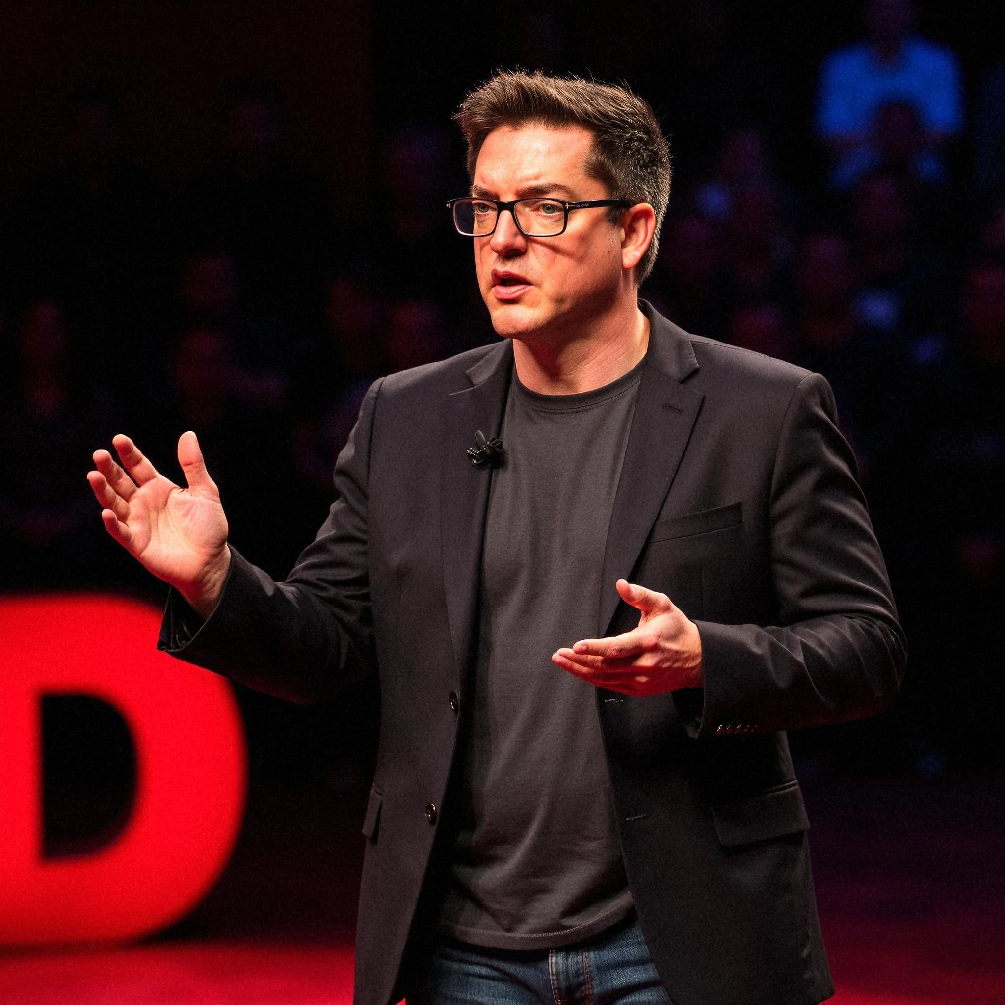 Professional headshot example: Man Stage Black Jacket Speaking — LinkedInHeadshots.ai