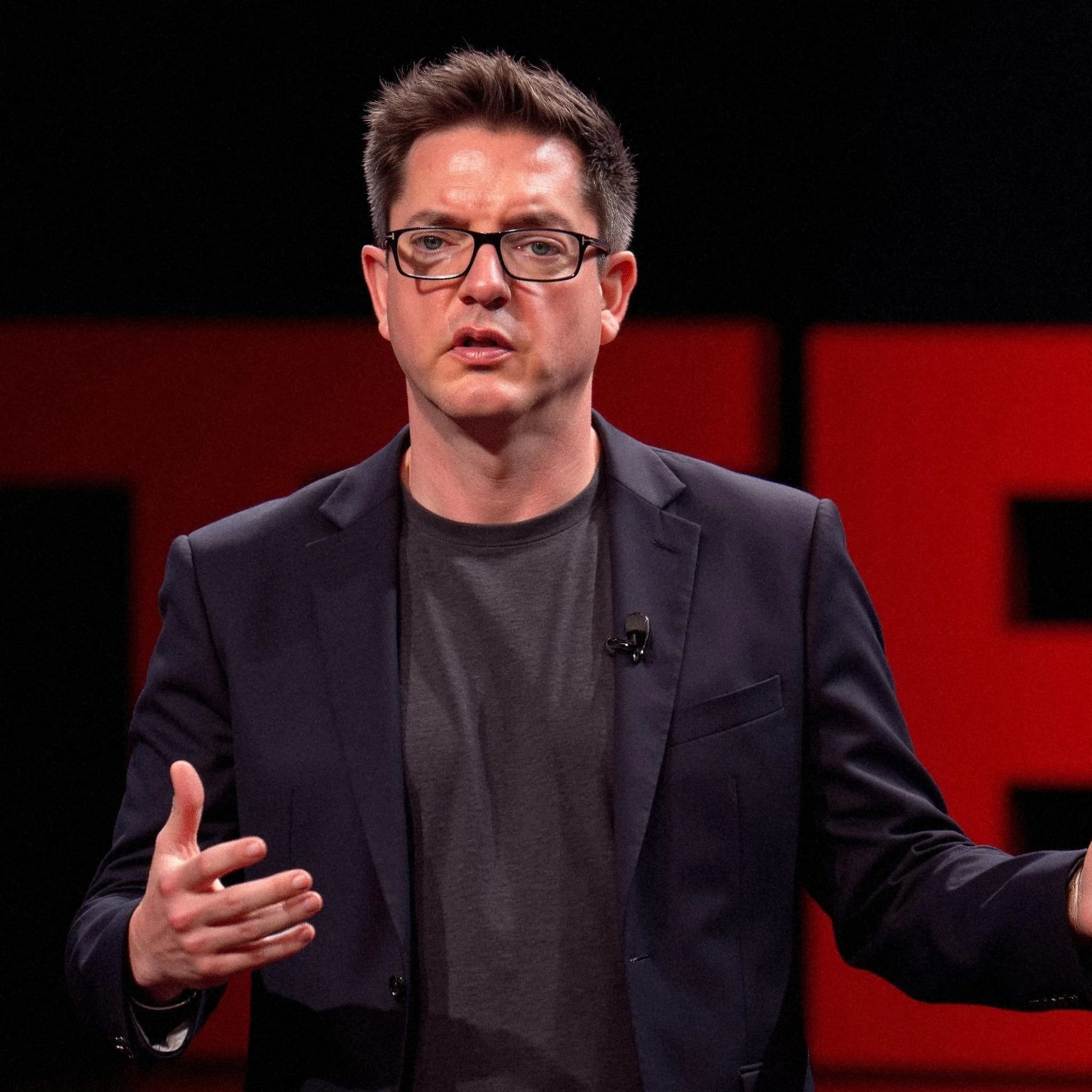 Professional headshot example: Man Stage Black Jacket Speaking 3 — LinkedInHeadshots.ai