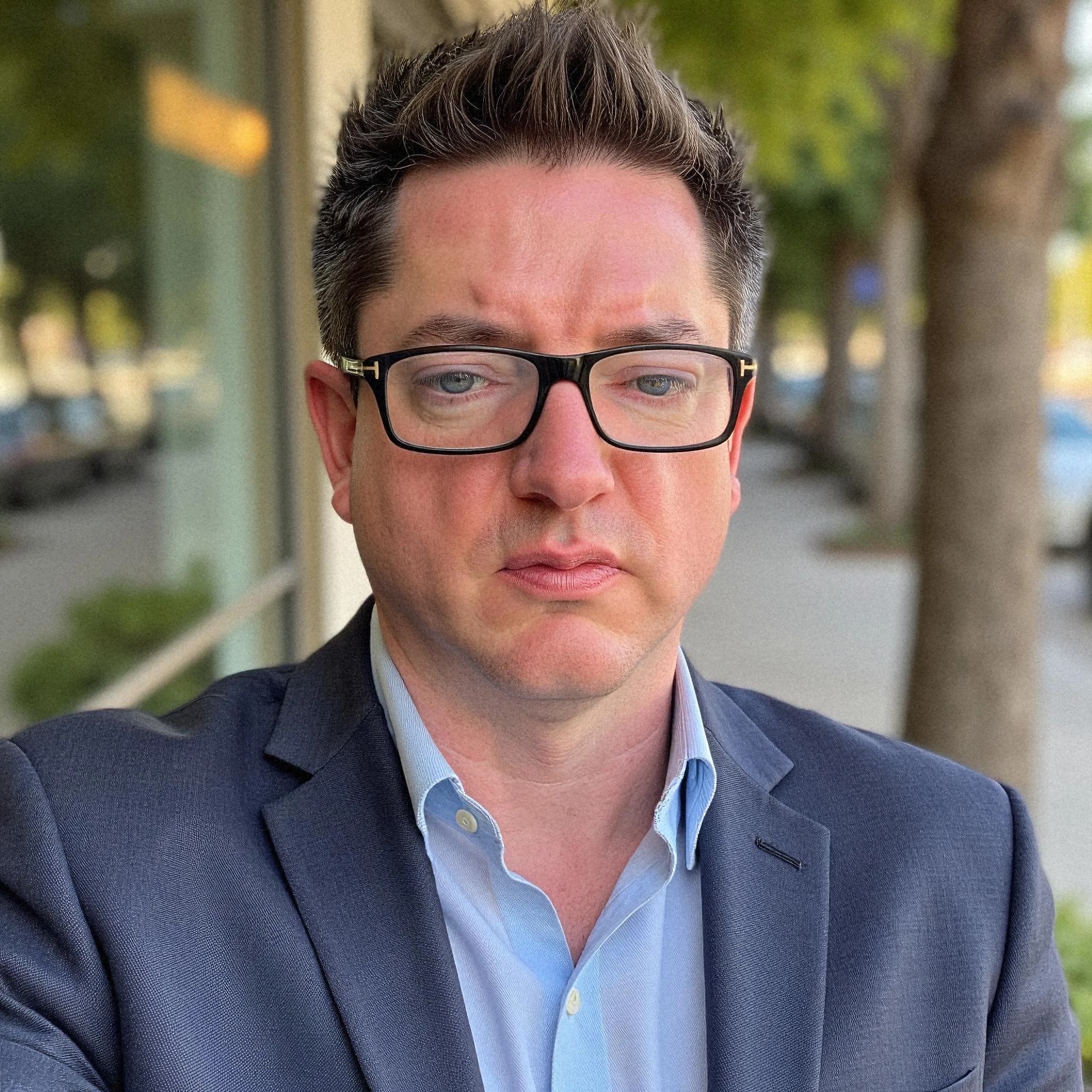 Professional headshot example: Man Street Blue Suit Serious Expression — LinkedInHeadshots.ai