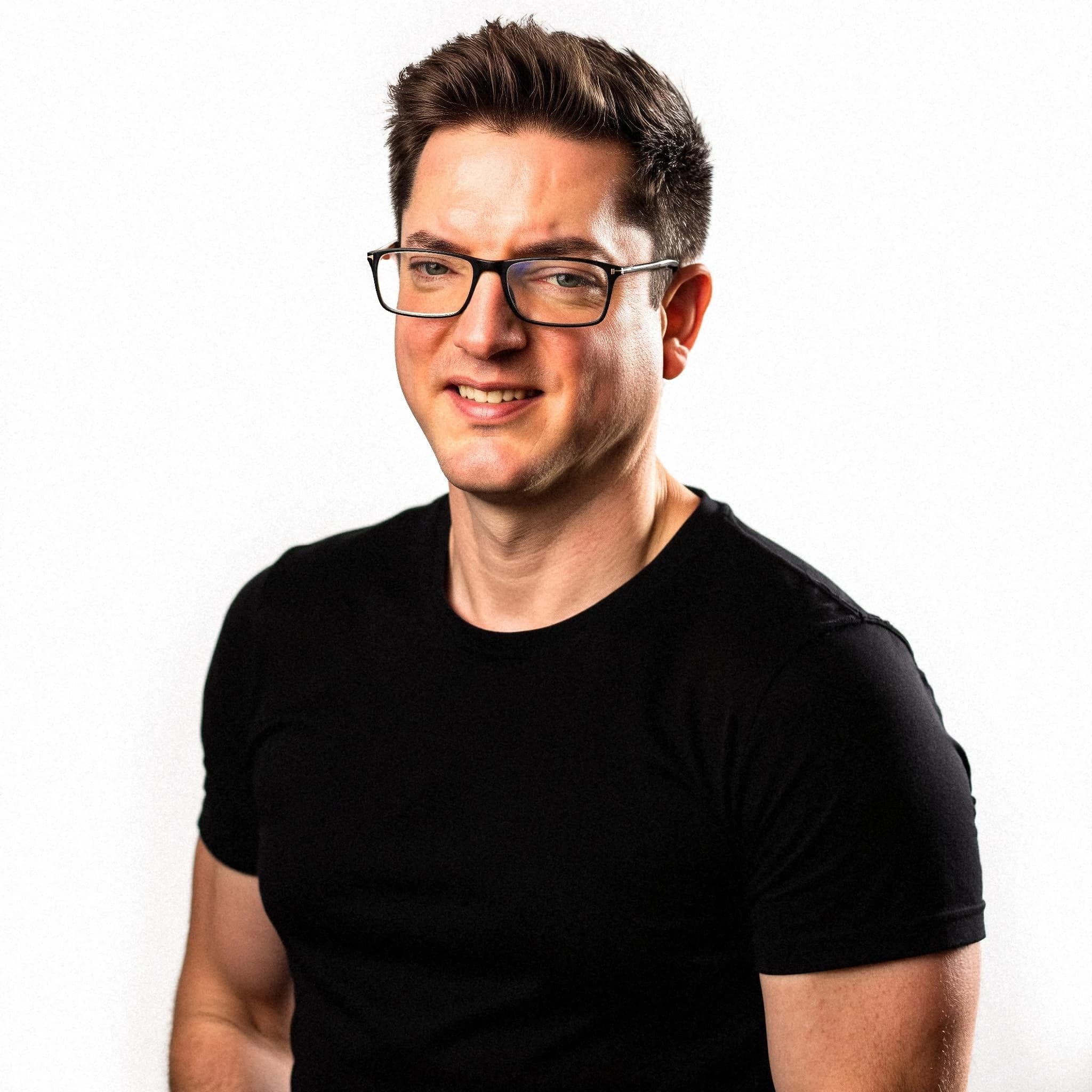 Professional headshot example: Man Studio Black Shirt Smiling — LinkedInHeadshots.ai