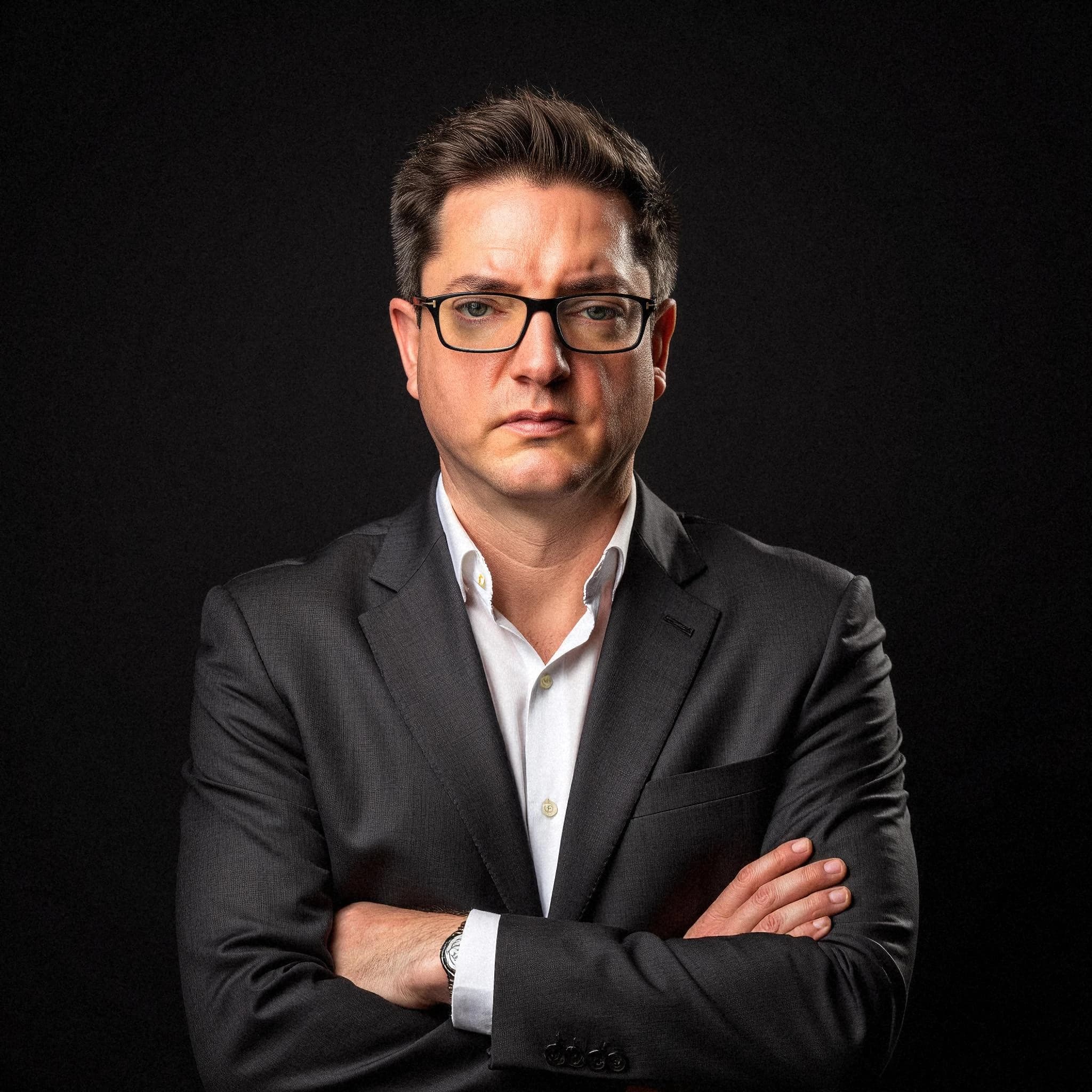 Professional headshot example: Man Studio Black Suit Crossed Arms 2 — LinkedInHeadshots.ai