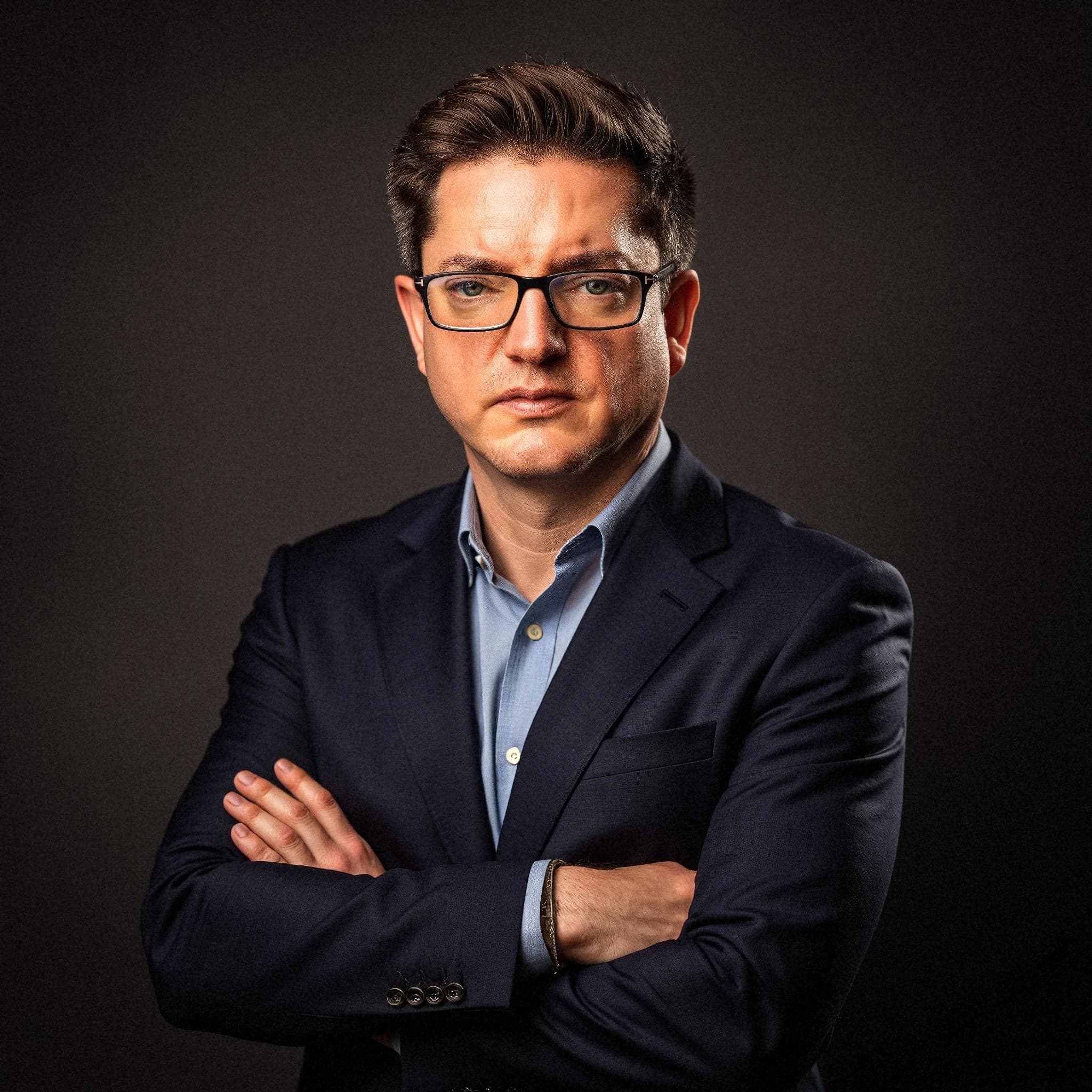 Professional headshot example: Man Studio Suit Arms Crossed — LinkedInHeadshots.ai