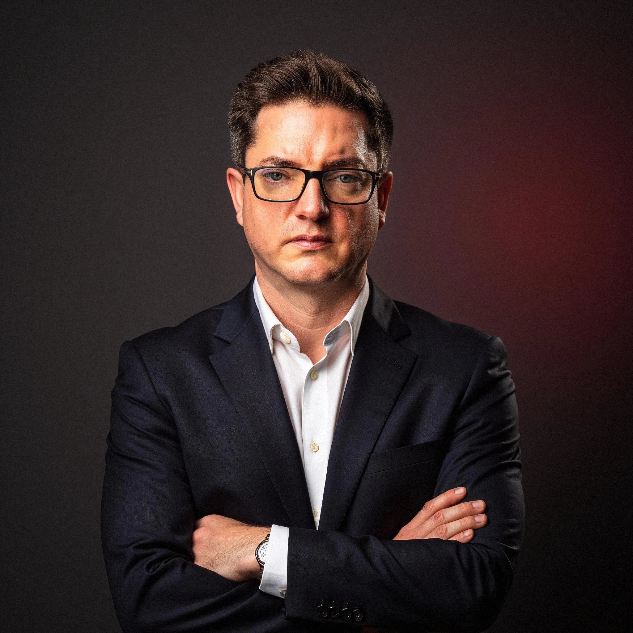 Professional headshot example: Man Studio Suit Arms Crossed 2 — LinkedInHeadshots.ai