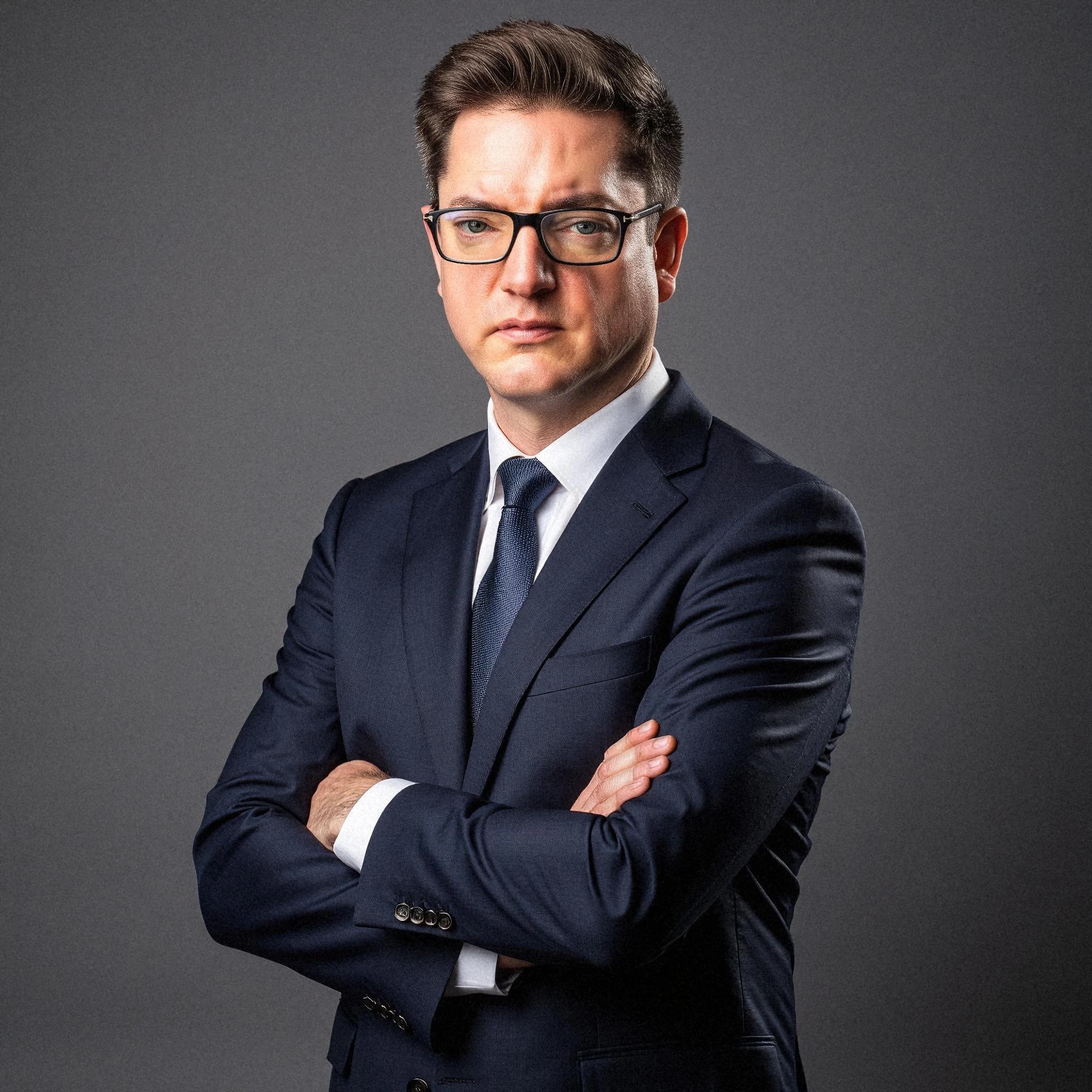 Professional headshot example: Man Studio Suit Arms Crossed 3 — LinkedInHeadshots.ai