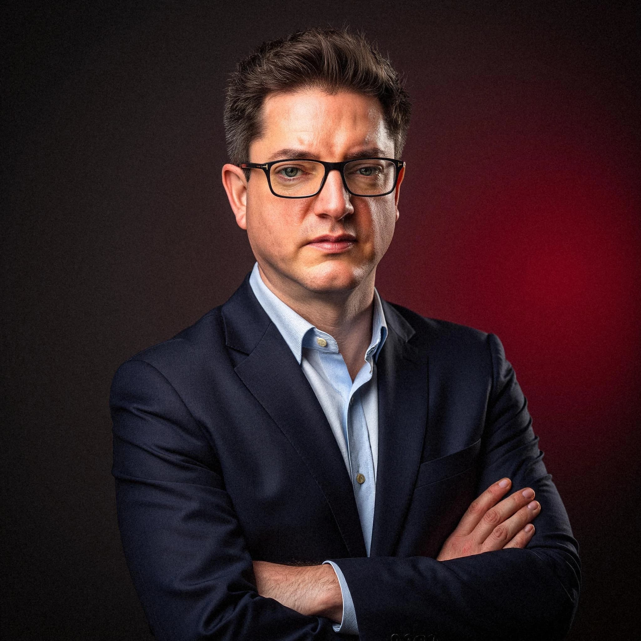 Professional headshot example: Man Studio Suit Crossed Arms 10 — LinkedInHeadshots.ai