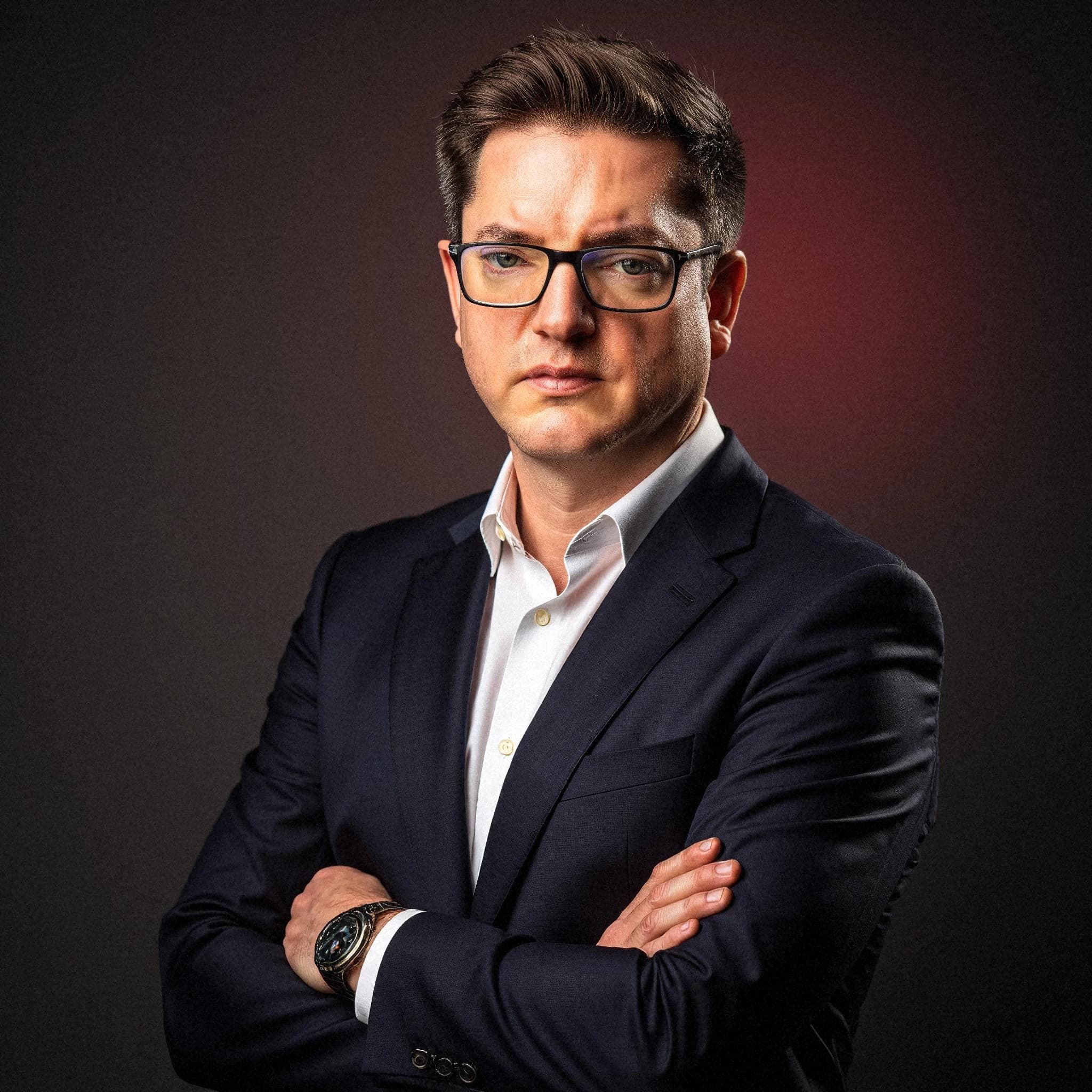 Professional headshot example: Man Studio Suit Crossed Arms 13 — LinkedInHeadshots.ai