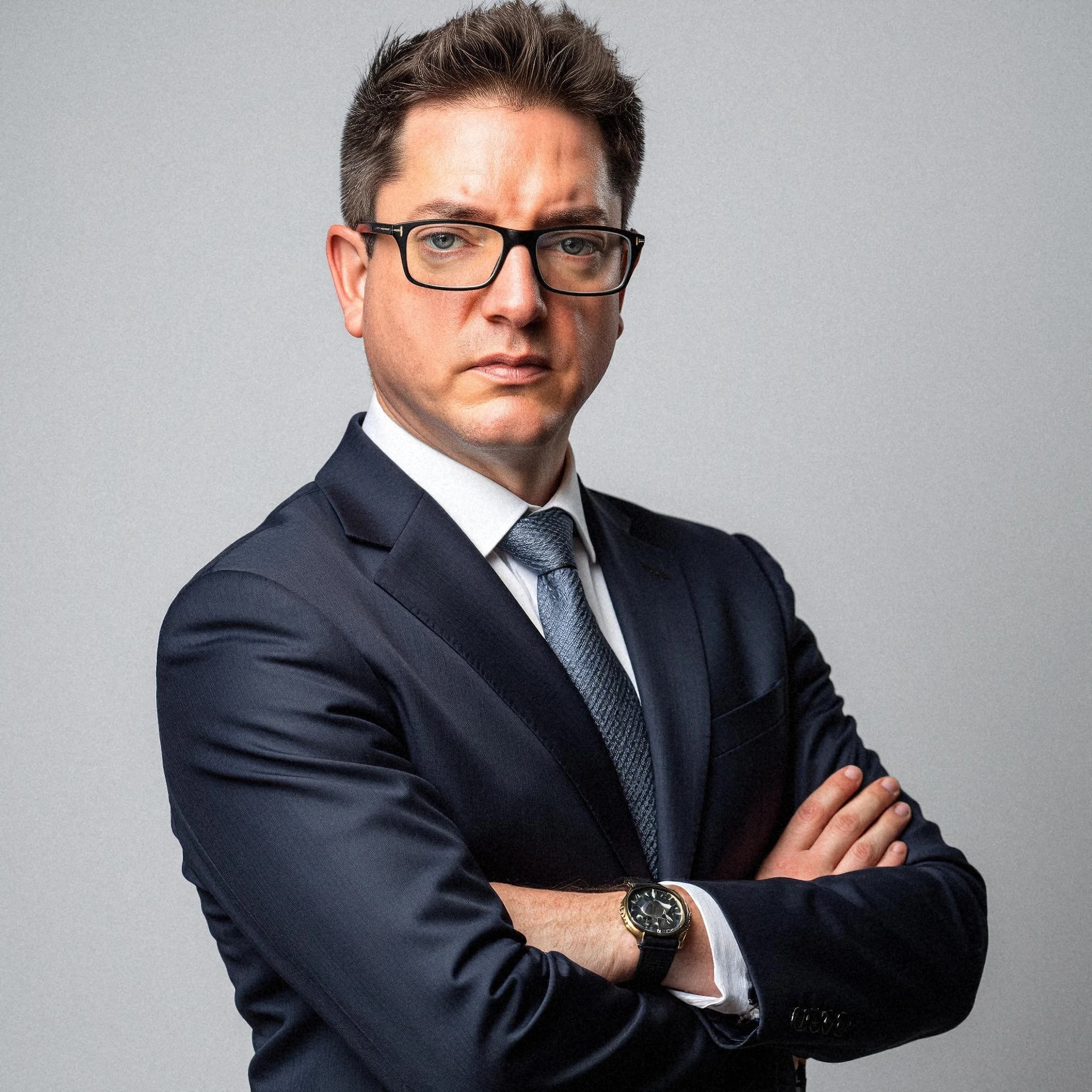 Professional headshot example: Man Studio Suit Crossed Arms 15 — LinkedInHeadshots.ai