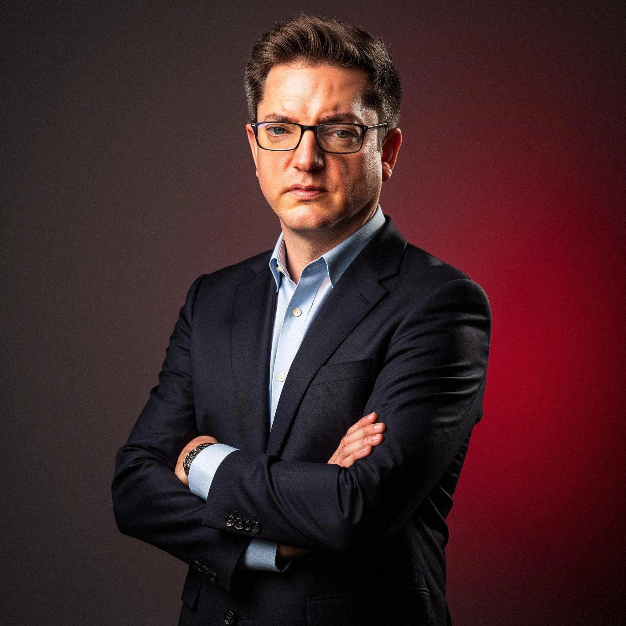 Professional headshot example: Man Studio Suit Crossed Arms 2 — LinkedInHeadshots.ai