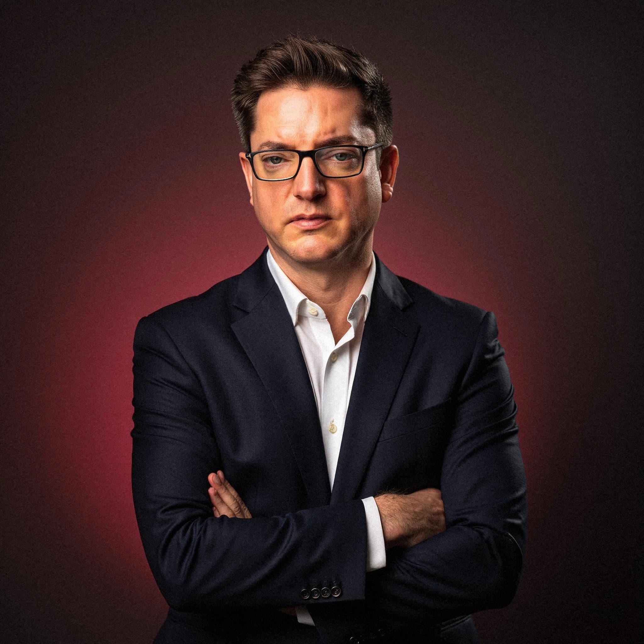 Professional headshot example: Man Studio Suit Crossed Arms 8 — LinkedInHeadshots.ai