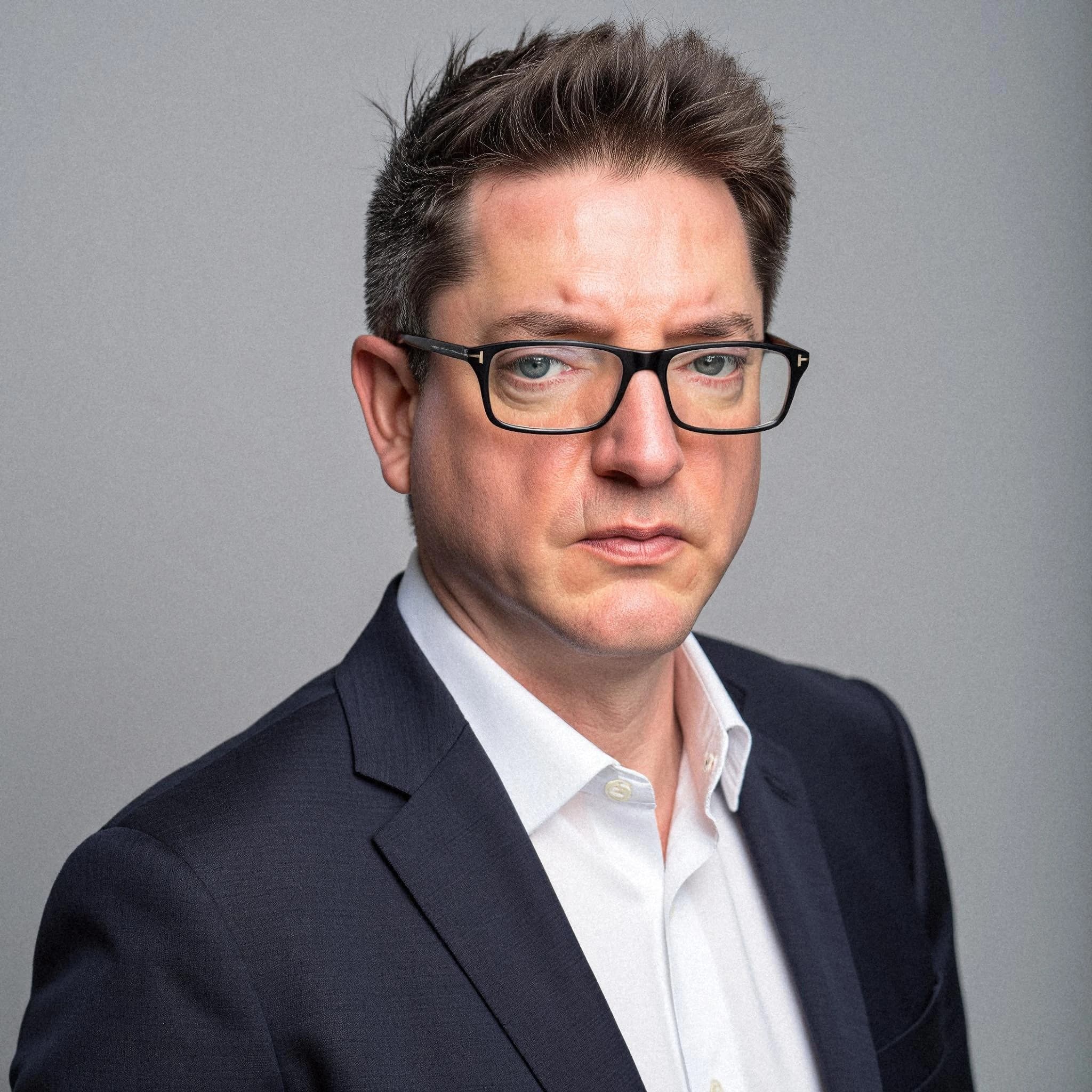 Professional headshot example: Man Studio Suit Glasses Portrait 3 — LinkedInHeadshots.ai