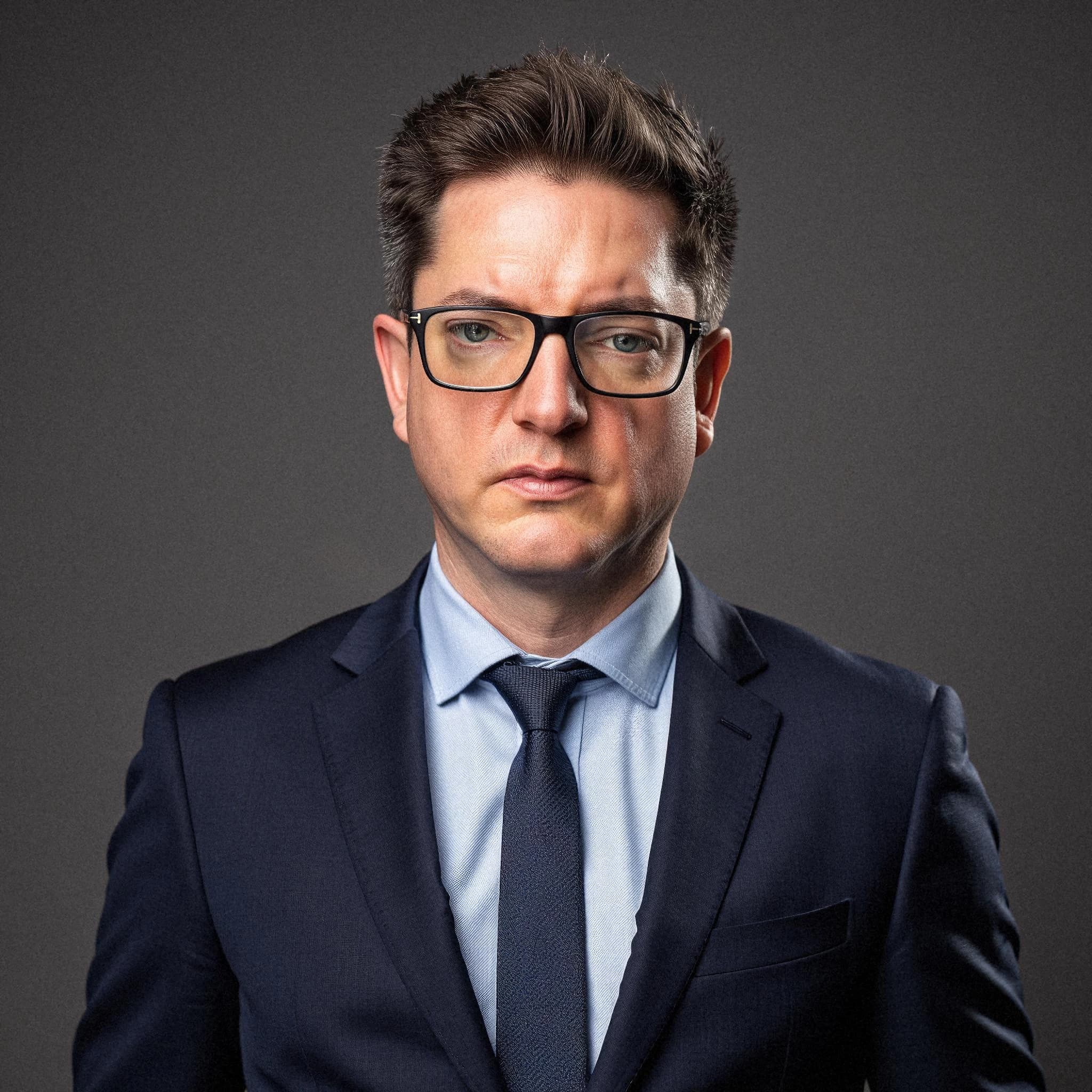 Professional headshot example: Man Studio Suit Glasses Serious 5 — LinkedInHeadshots.ai