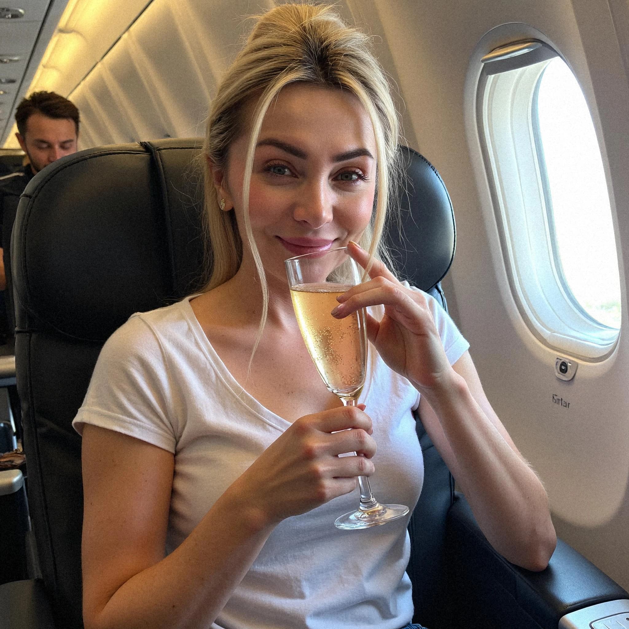 Professional headshot example: Woman Airplane White Shirt Holding Champagne — LinkedInHeadshots.ai