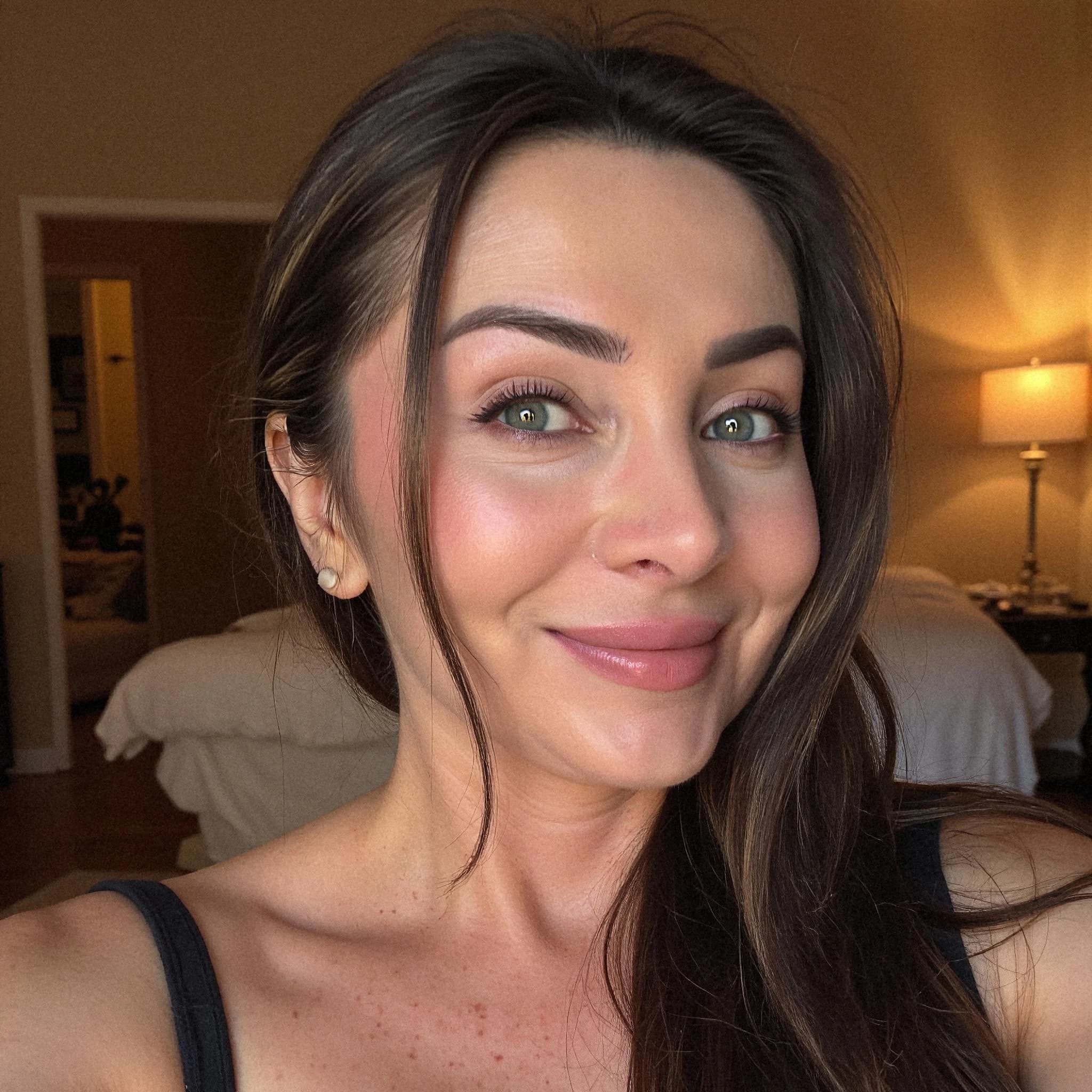 Professional headshot example: Woman Bedroom Black Top Smiling — LinkedInHeadshots.ai