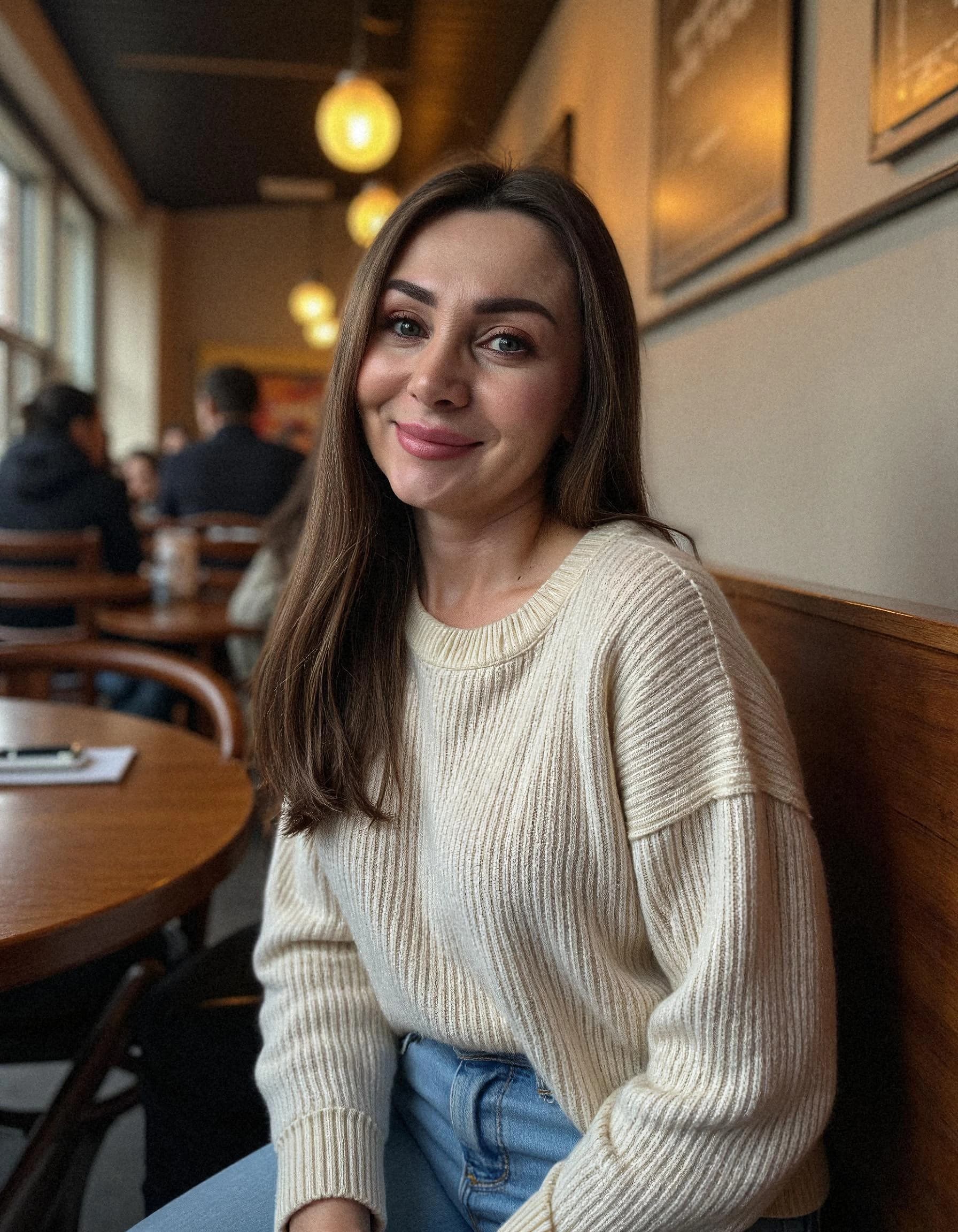 Professional headshot example: Woman Cafe Cream Sweater Smiling — LinkedInHeadshots.ai