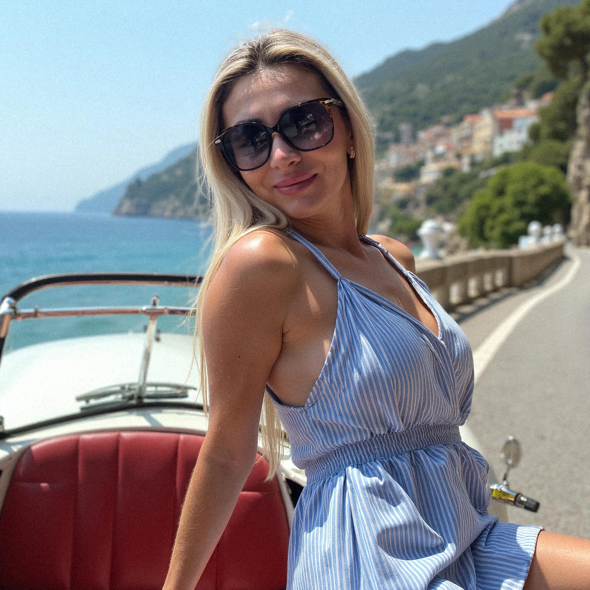 Professional headshot example: Woman Coast Blue Dress Sitting — LinkedInHeadshots.ai