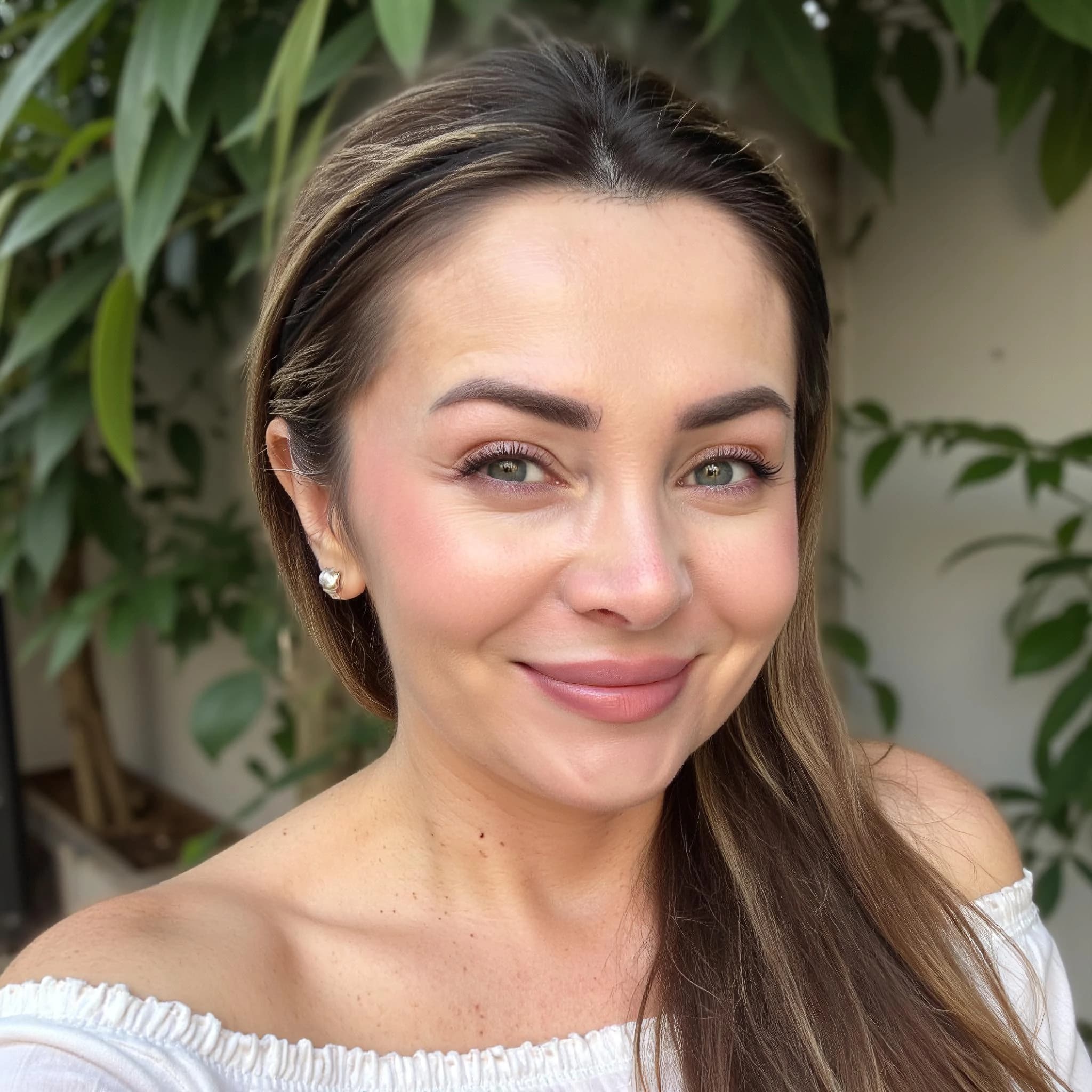 Professional headshot example: Woman Garden White Top Smiling — LinkedInHeadshots.ai