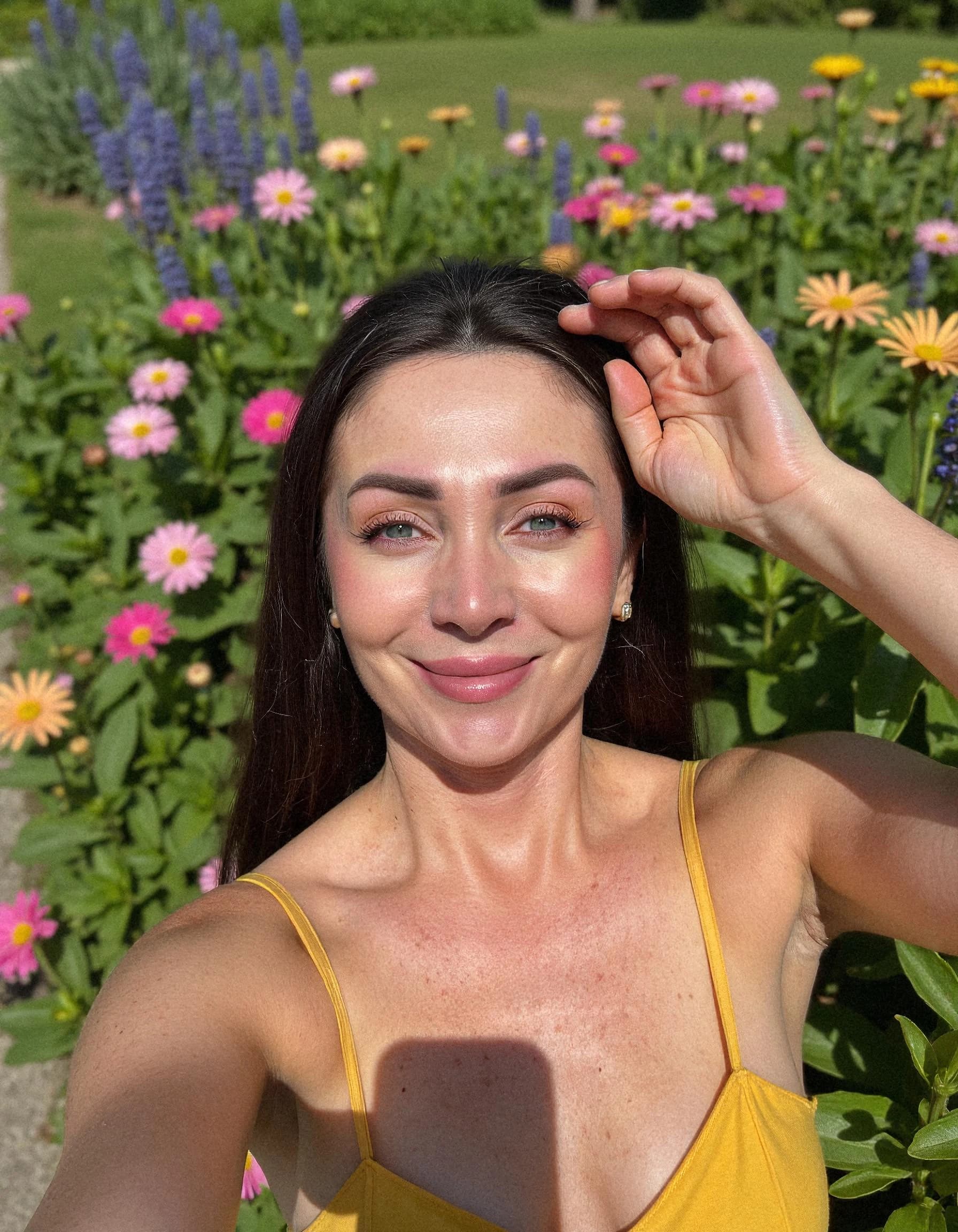Professional headshot example: Woman Garden Yellow Top Selfie — LinkedInHeadshots.ai