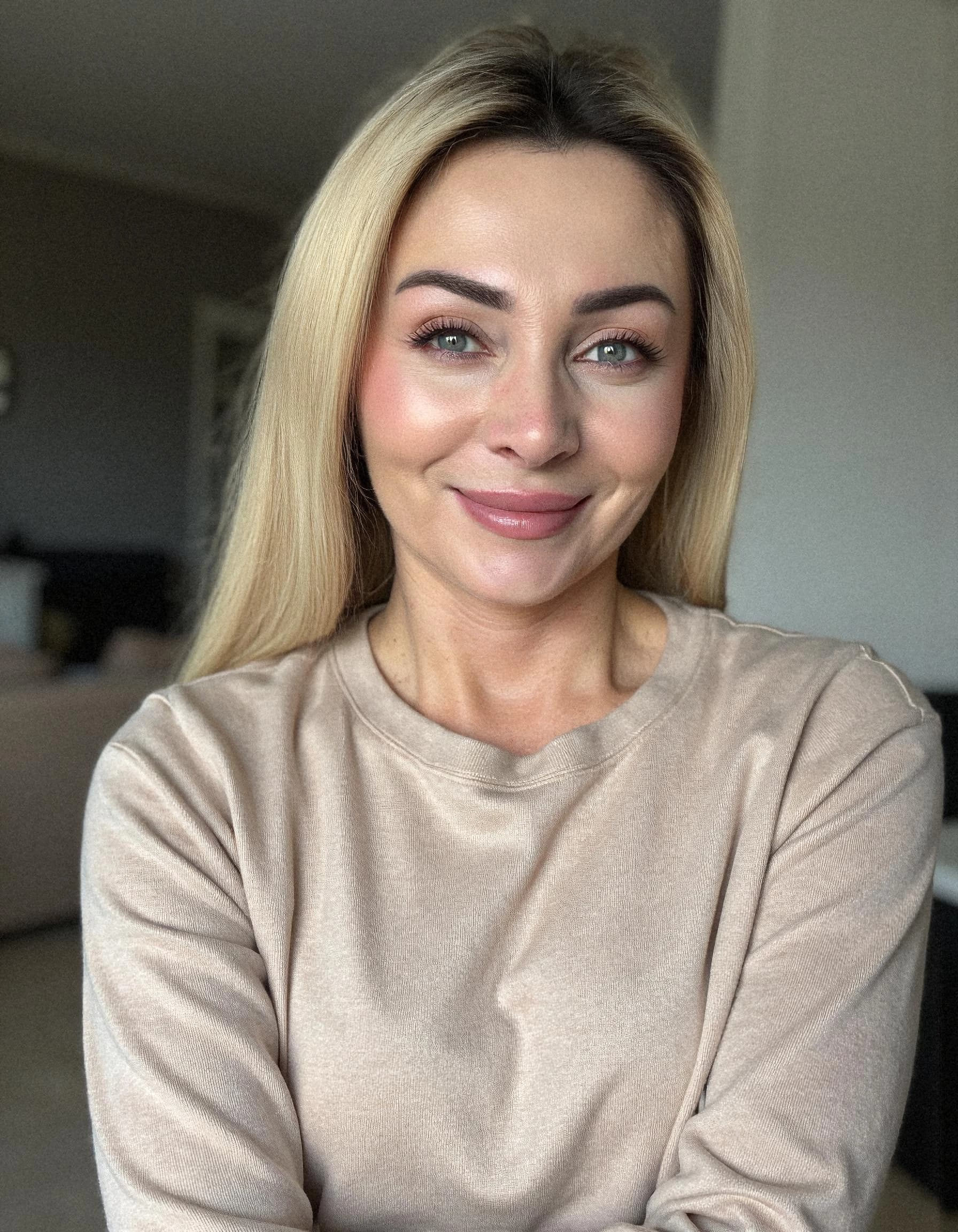 Professional headshot example: Woman Home Beige Sweater Smiling — LinkedInHeadshots.ai
