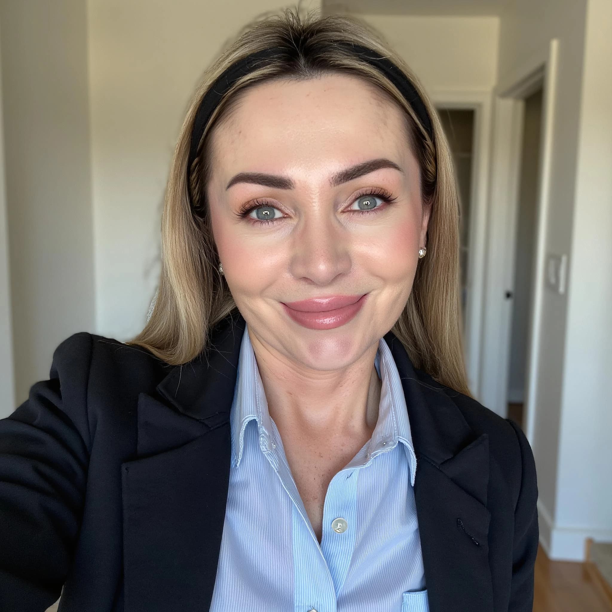 Professional headshot example: Woman Home Black Blazer Selfie — LinkedInHeadshots.ai