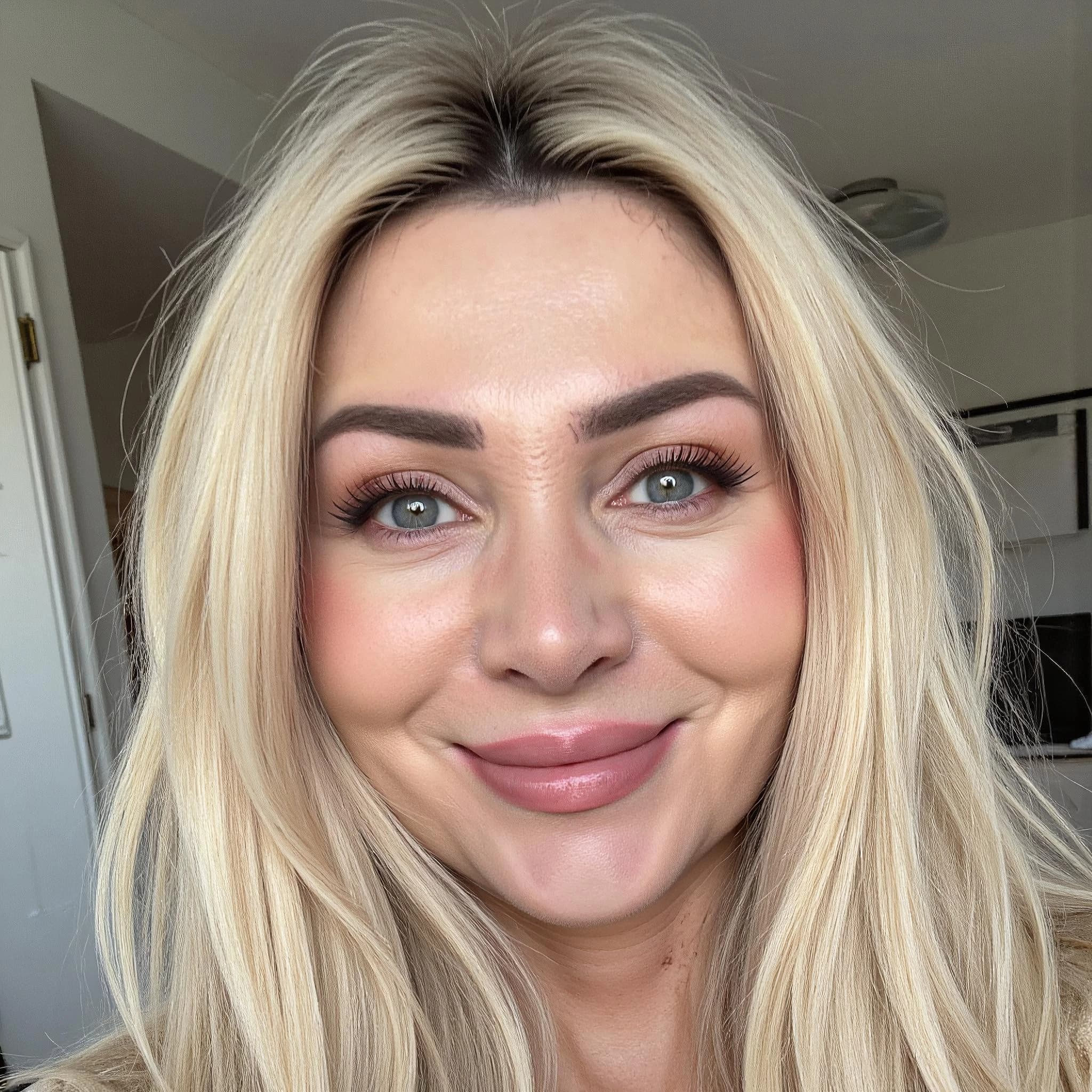 Professional headshot example: Woman Home Blonde Smiling Headshot — LinkedInHeadshots.ai