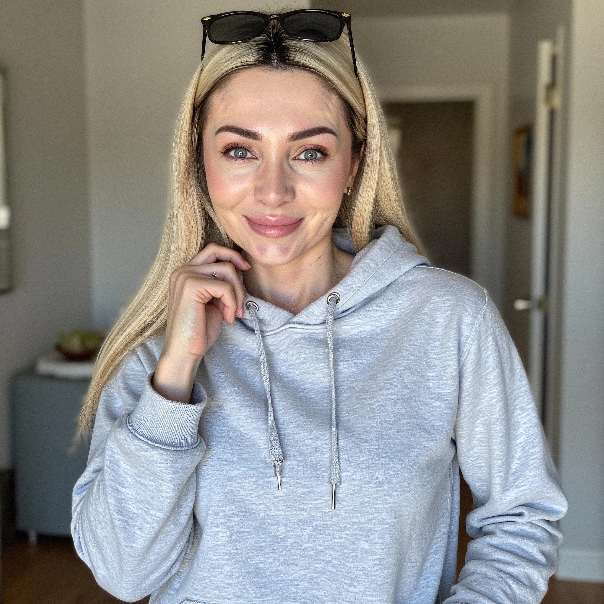 Professional headshot example: Woman Home Gray Hoodie Smiling 3 — LinkedInHeadshots.ai