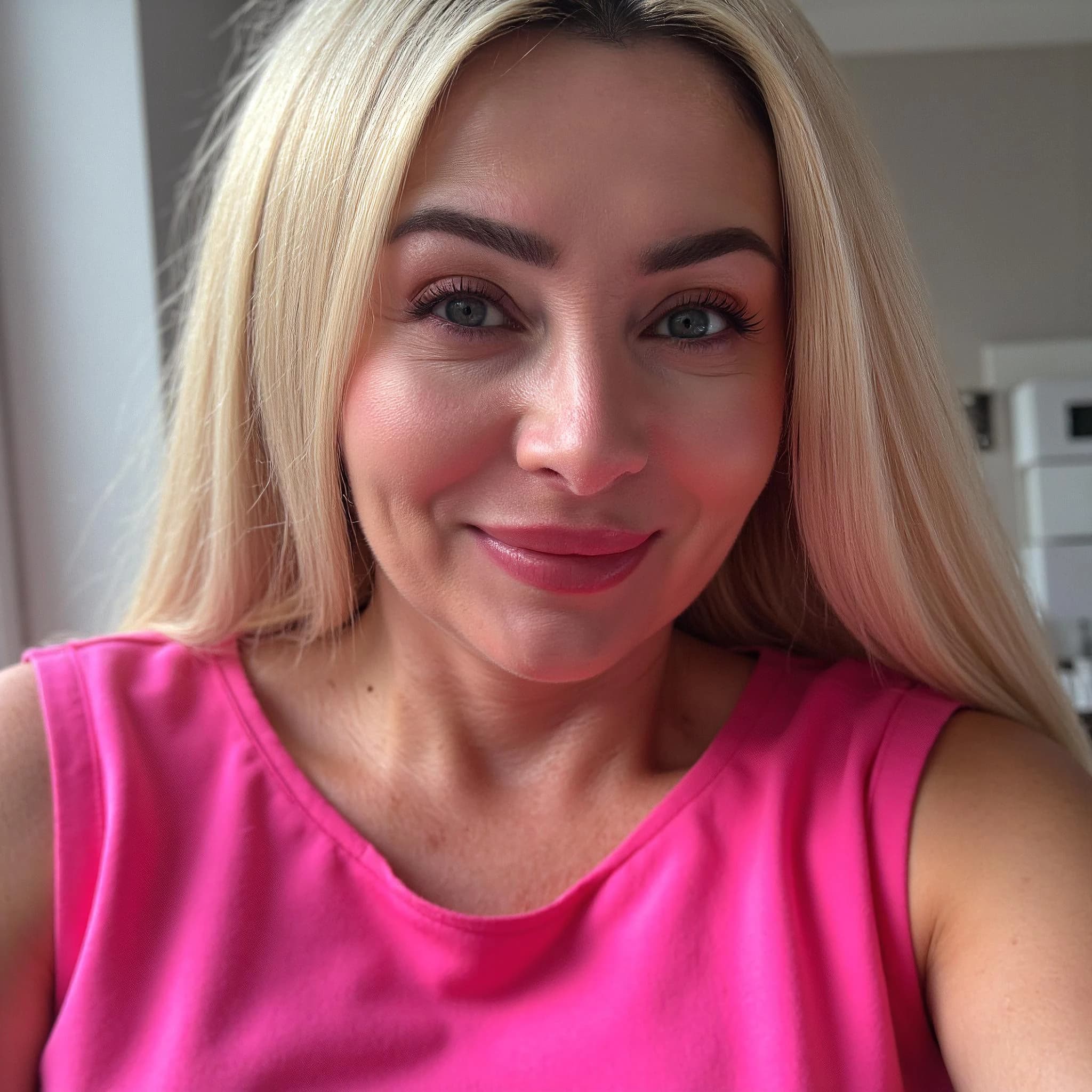 Professional headshot example: Woman Home Pink Top Smiling — LinkedInHeadshots.ai