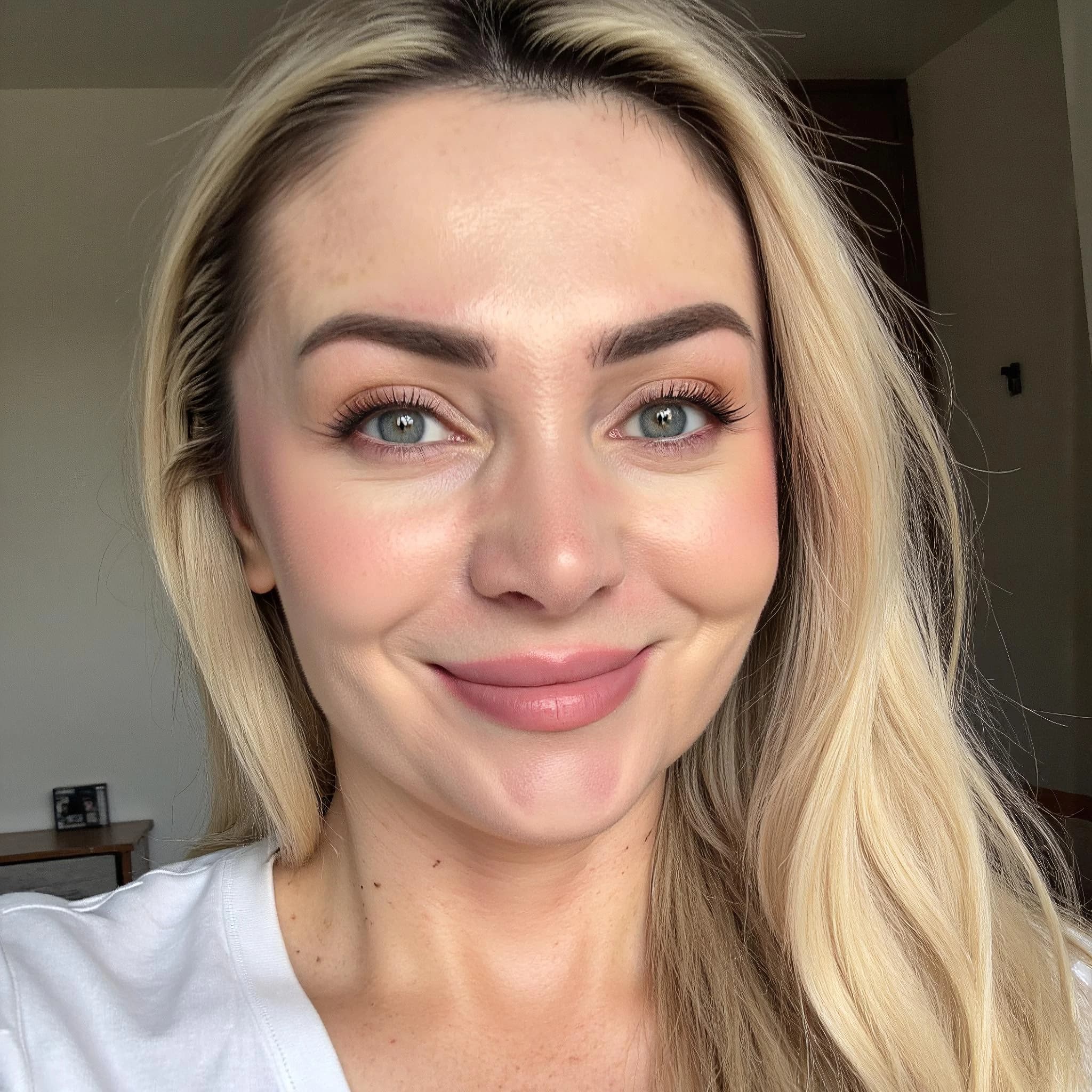 Professional headshot example: Woman Home White Top Smiling Headshot — LinkedInHeadshots.ai