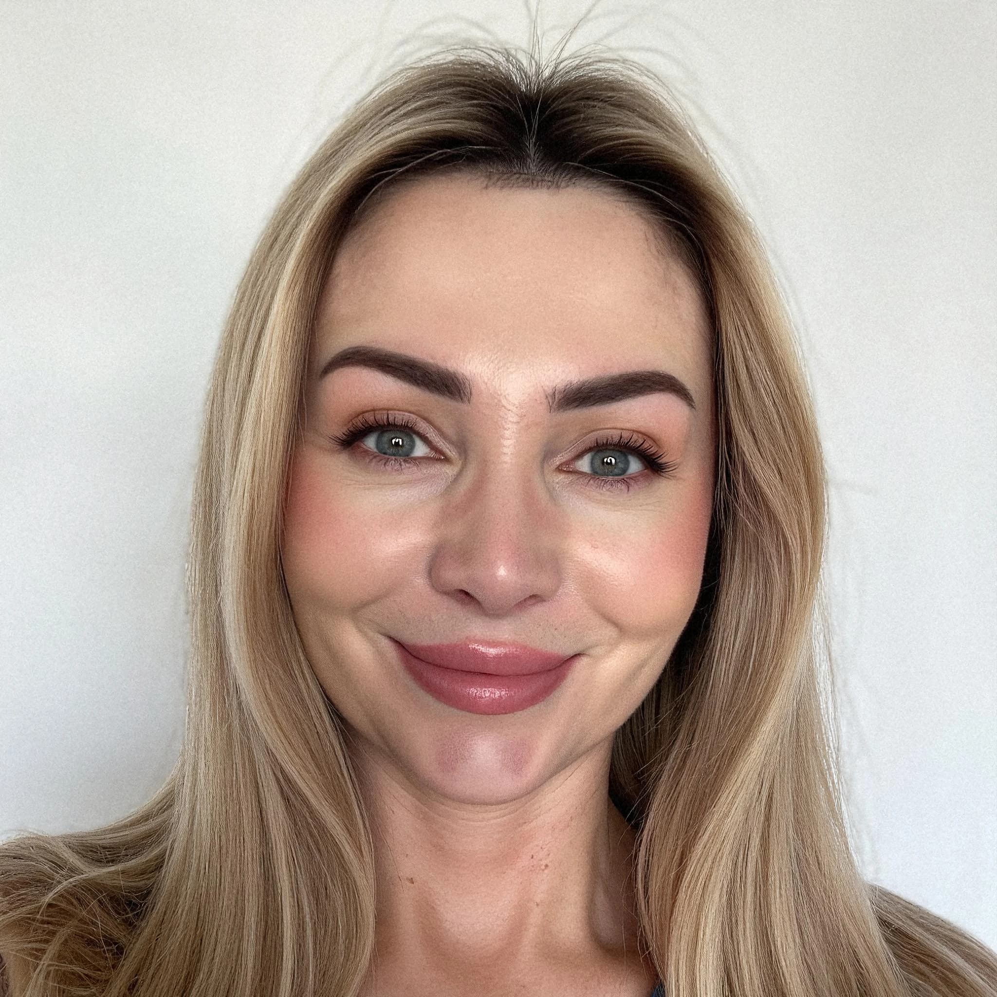 Professional headshot example: Woman Indoor Blonde Smiling Headshot — LinkedInHeadshots.ai