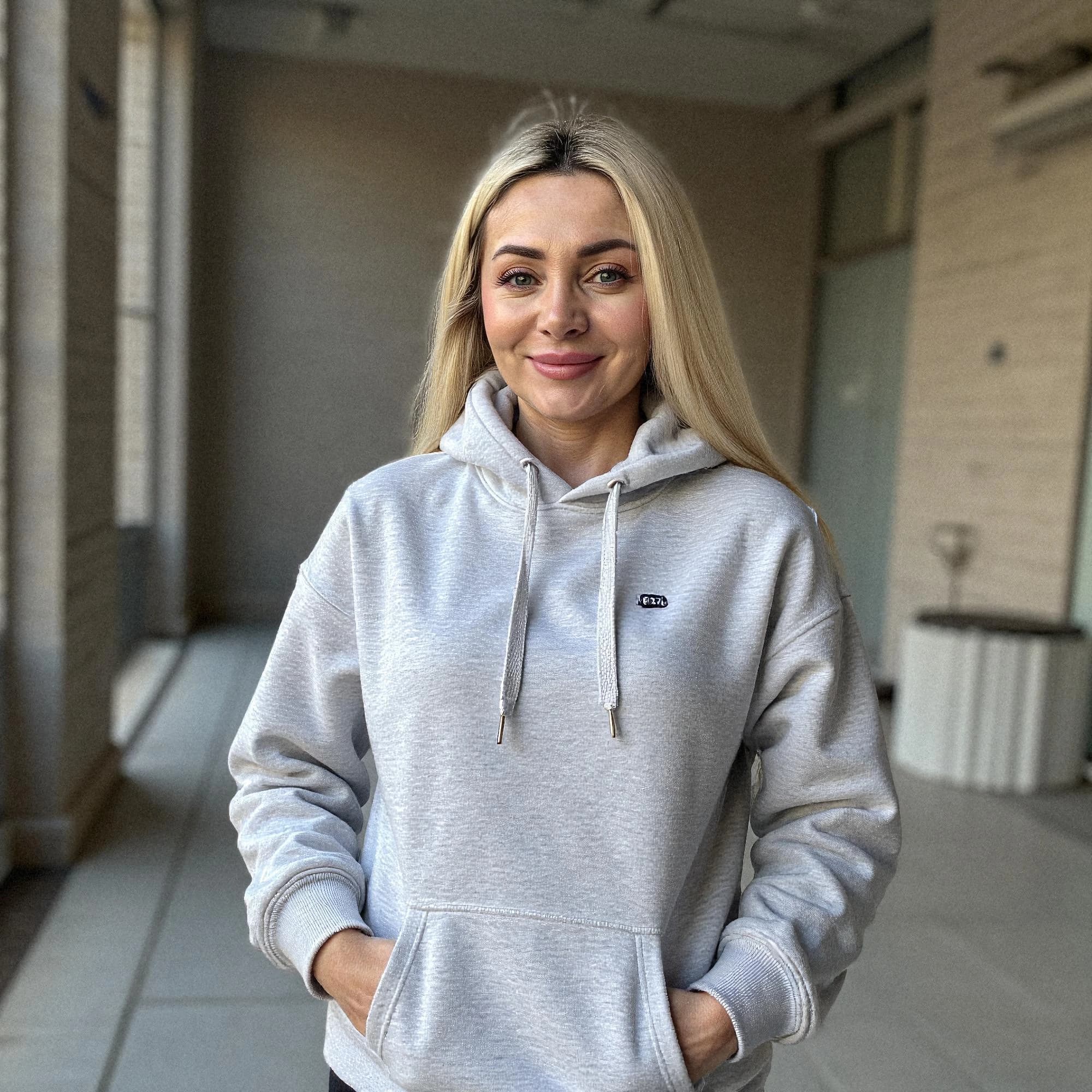 Professional headshot example: Woman Indoor Gray Hoodie Smiling — LinkedInHeadshots.ai