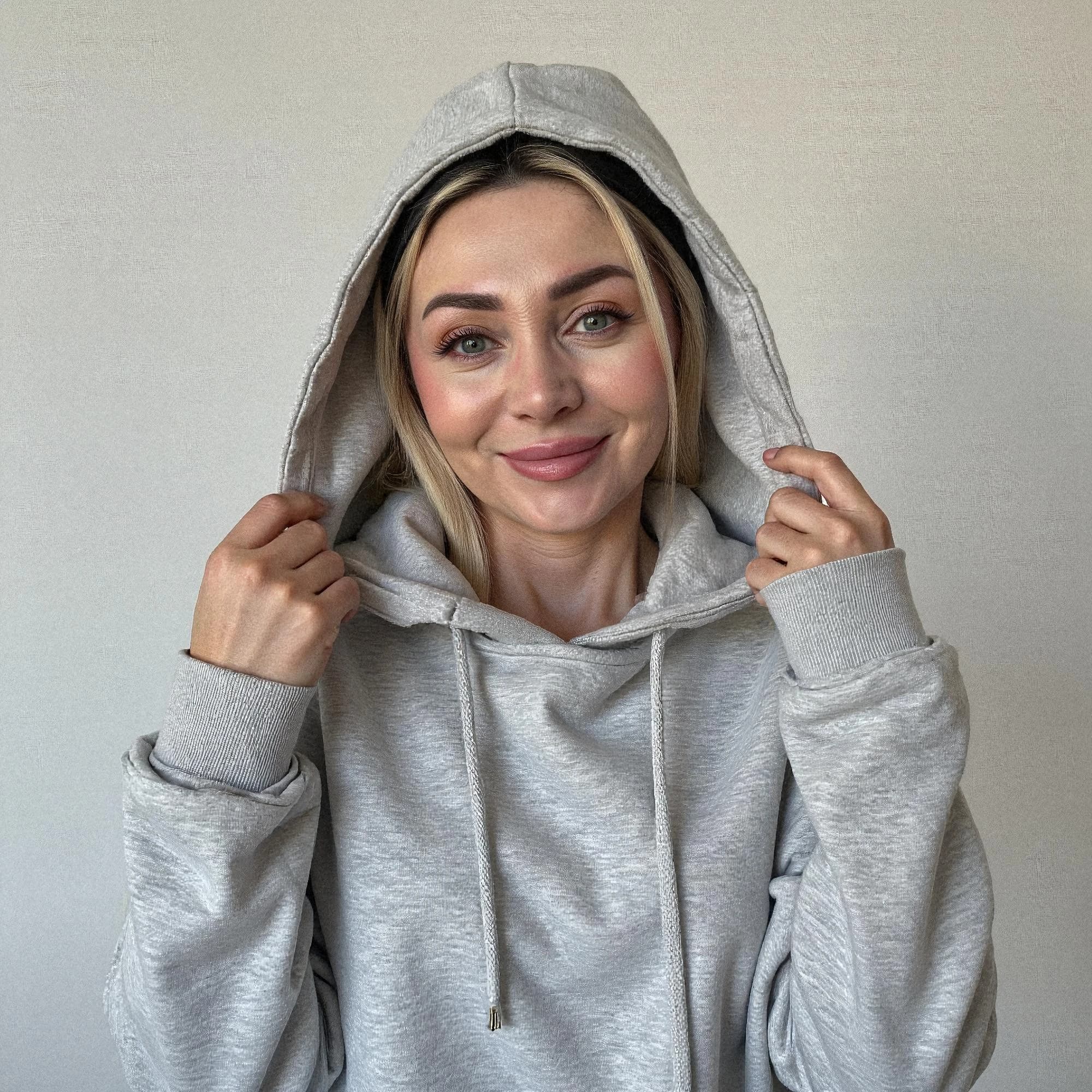 Professional headshot example: Woman Indoor Gray Hoodie Smiling 2 — LinkedInHeadshots.ai