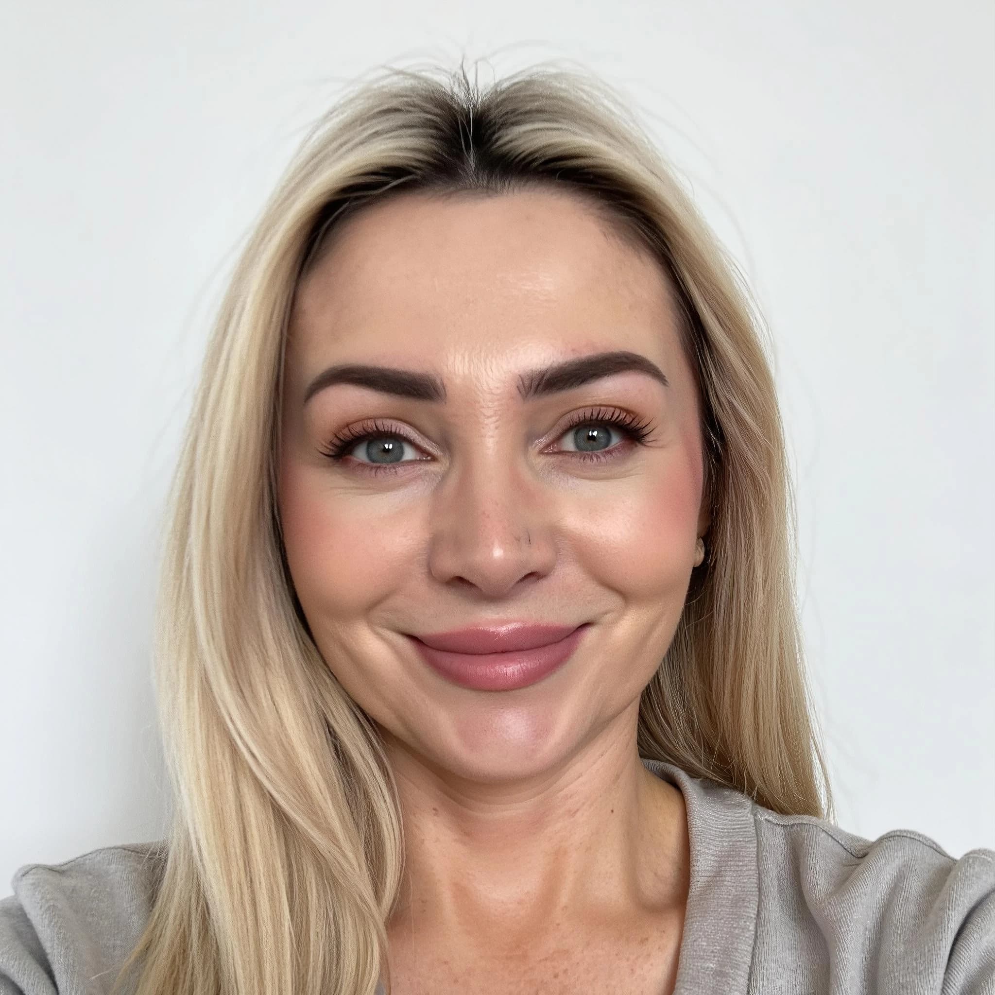 Professional headshot example: Woman Indoor Gray Top Smiling Headshot 3 — LinkedInHeadshots.ai