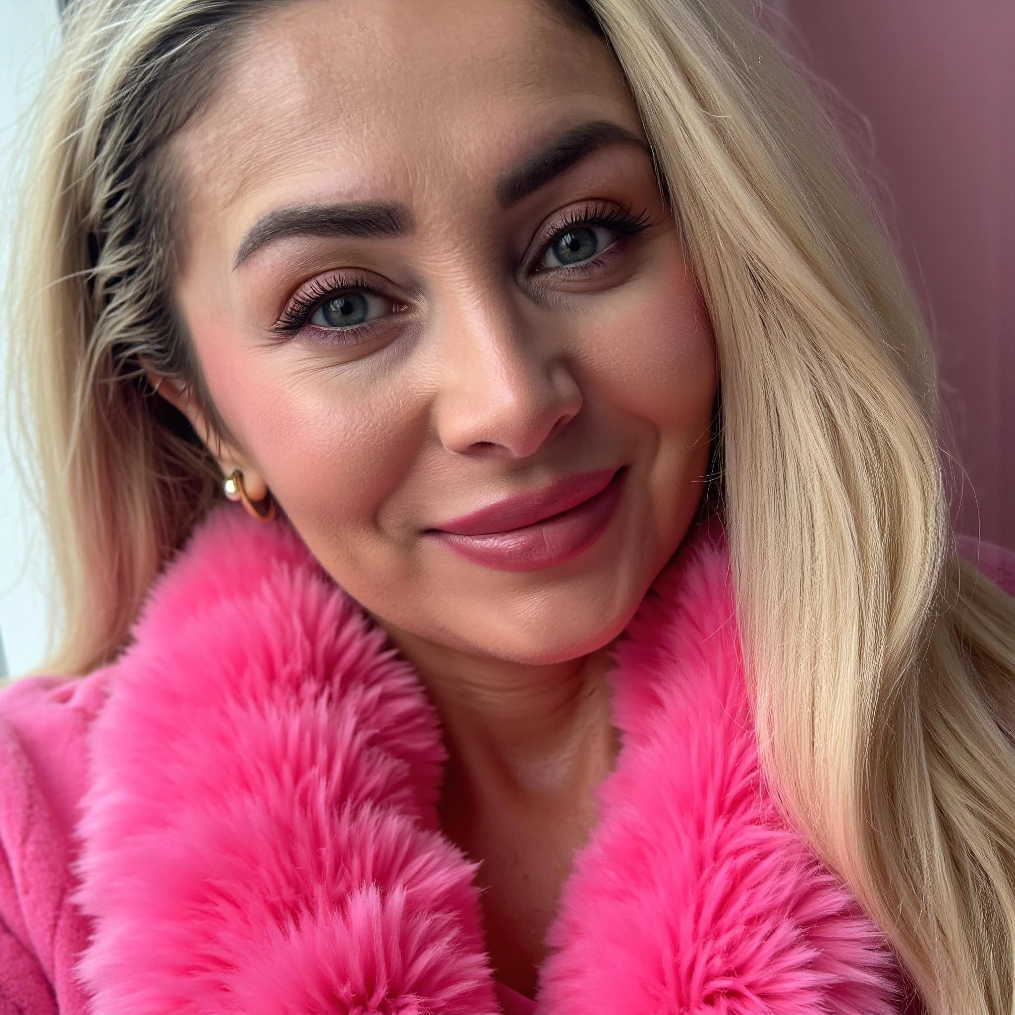 Professional headshot example: Woman Indoor Pink Coat Smiling — LinkedInHeadshots.ai