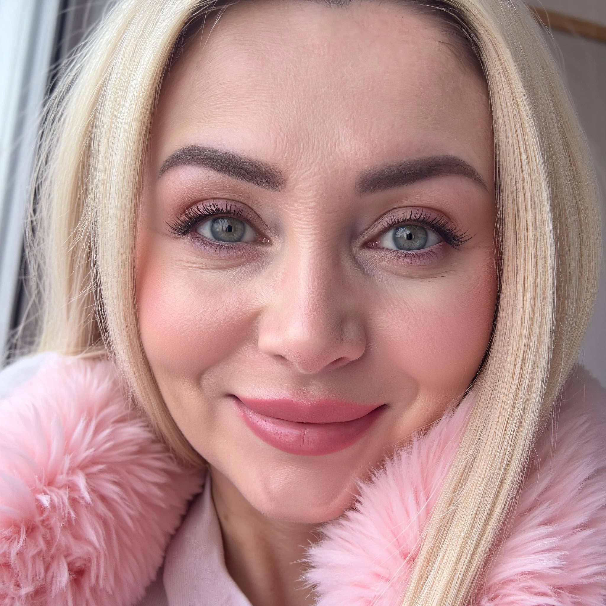 Professional headshot example: Woman Indoor Pink Coat Smiling 2 — LinkedInHeadshots.ai