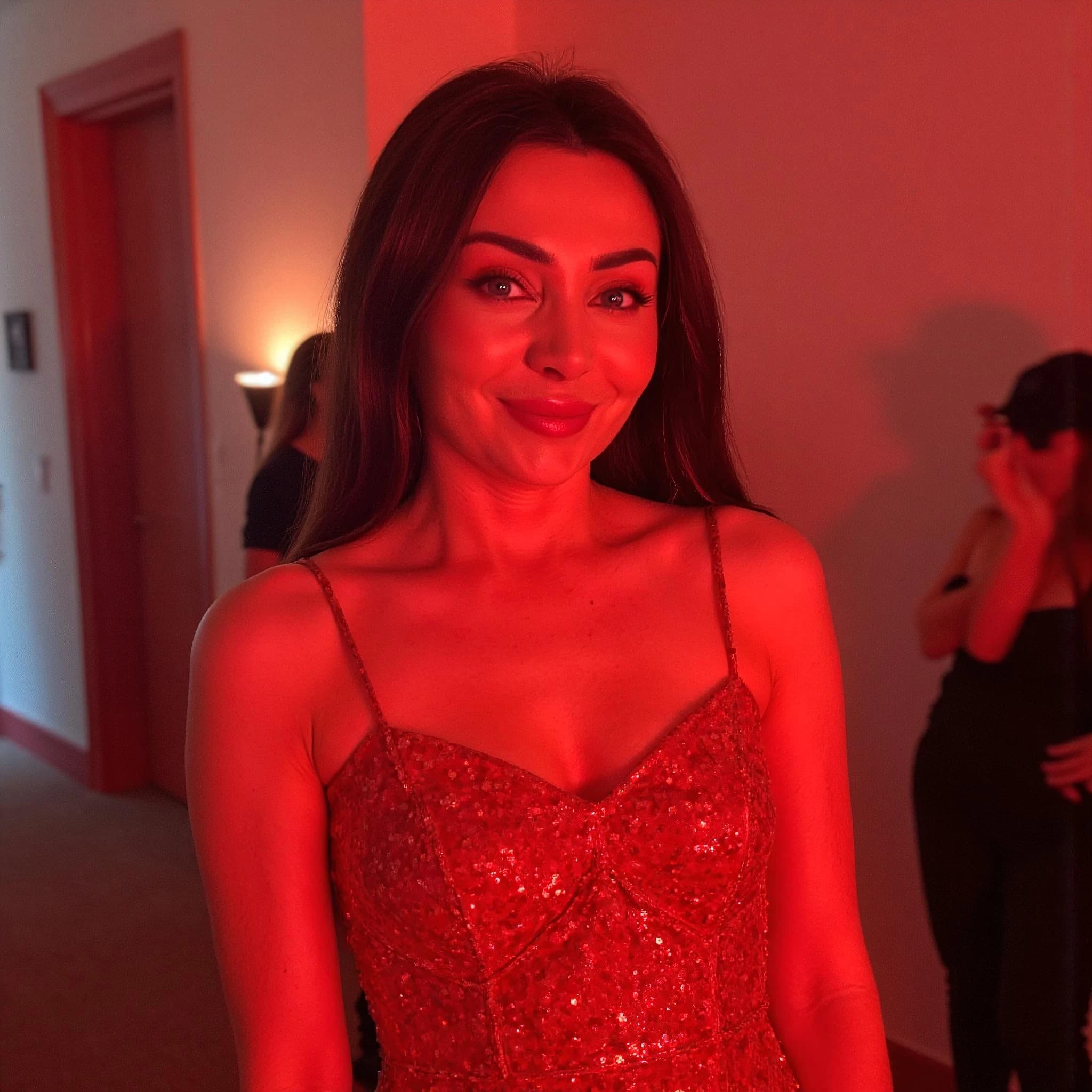 Professional headshot example: Woman Indoor Red Dress Smiling — LinkedInHeadshots.ai